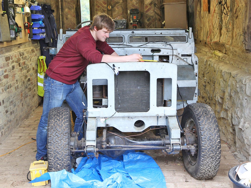 A student at work on restoring a series 3 Land Rover