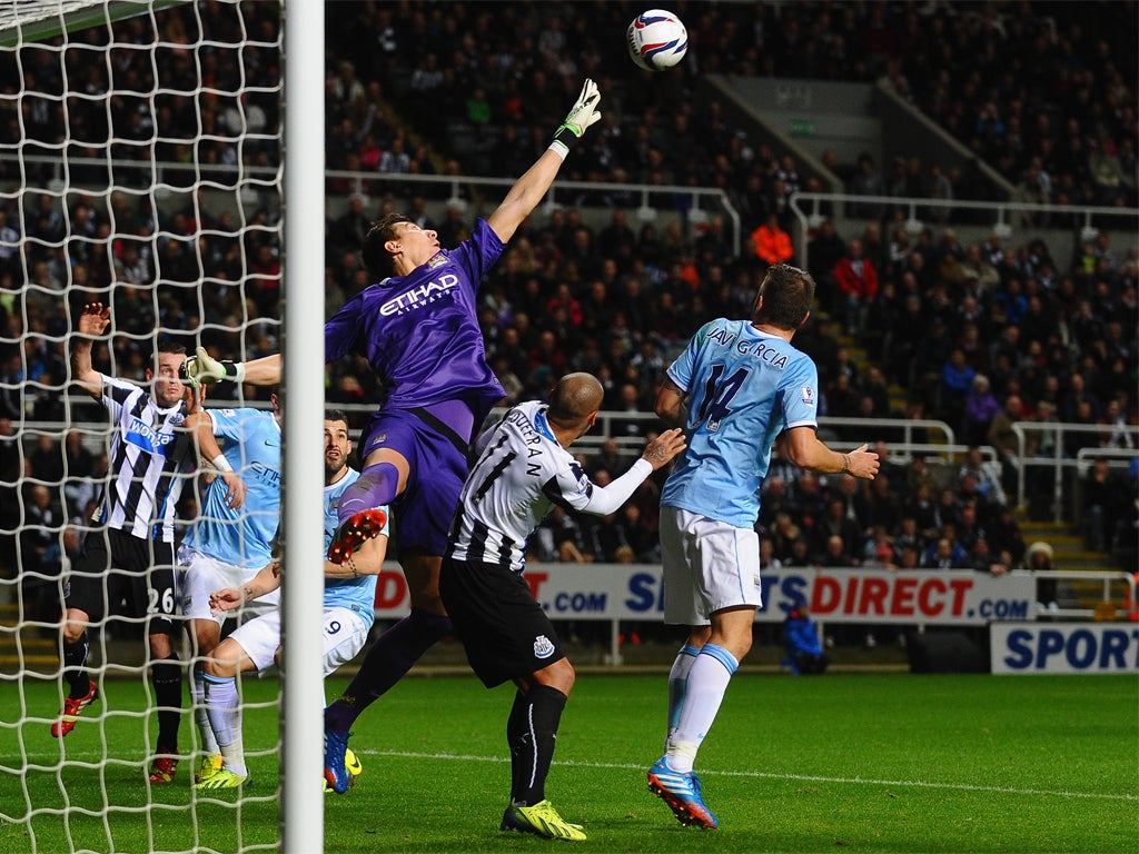 Costel Pantilimon uses all of his height to clear the ball from danger