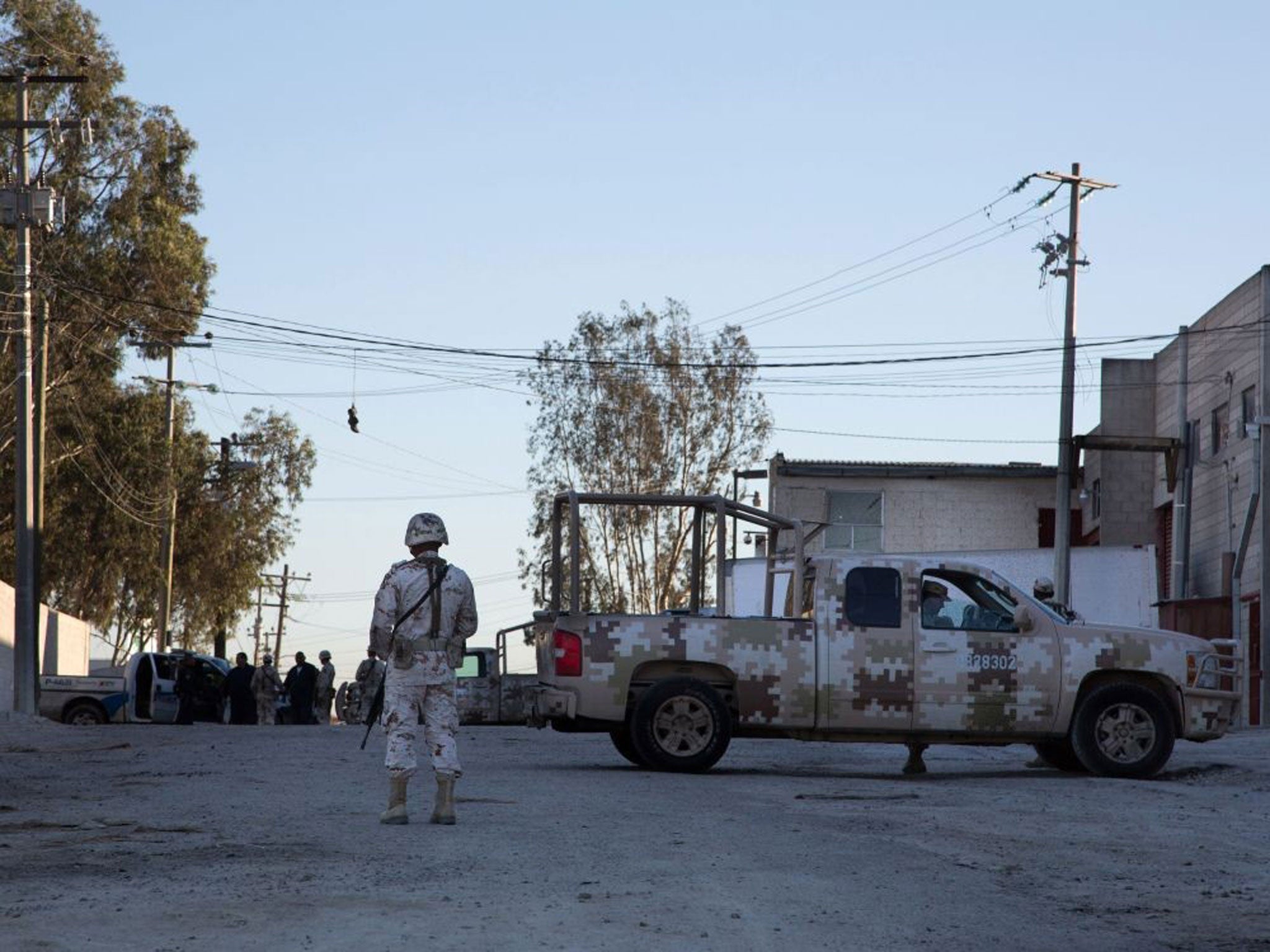 Mexican soldiers guard the warehouse where the tunnel begins