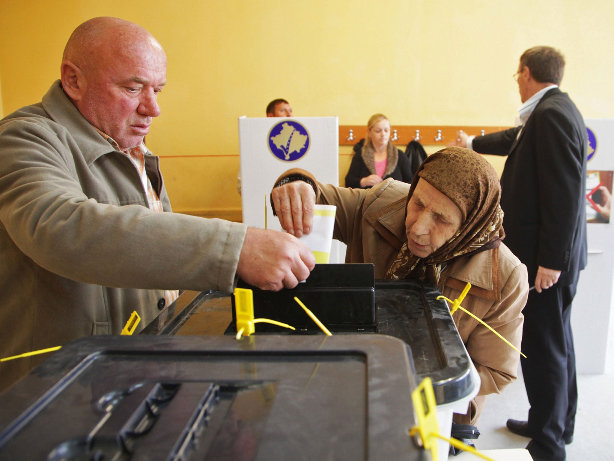 Ethnic Albanians cast their votes at the polling station in the town of Mitrovica