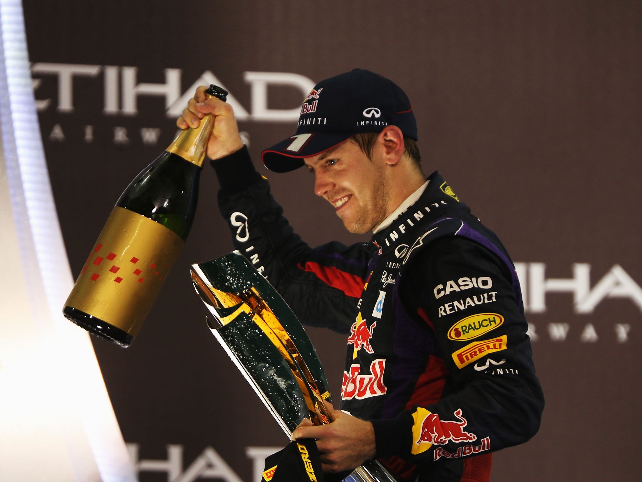 ABU DHABI, UNITED ARAB EMIRATES - NOVEMBER 03: Sebastian Vettel of Germany and Infiniti Red Bull Racing celebrates on the podium after winning the Abu Dhabi Formula One Grand Prix at the Yas Marina Circuit