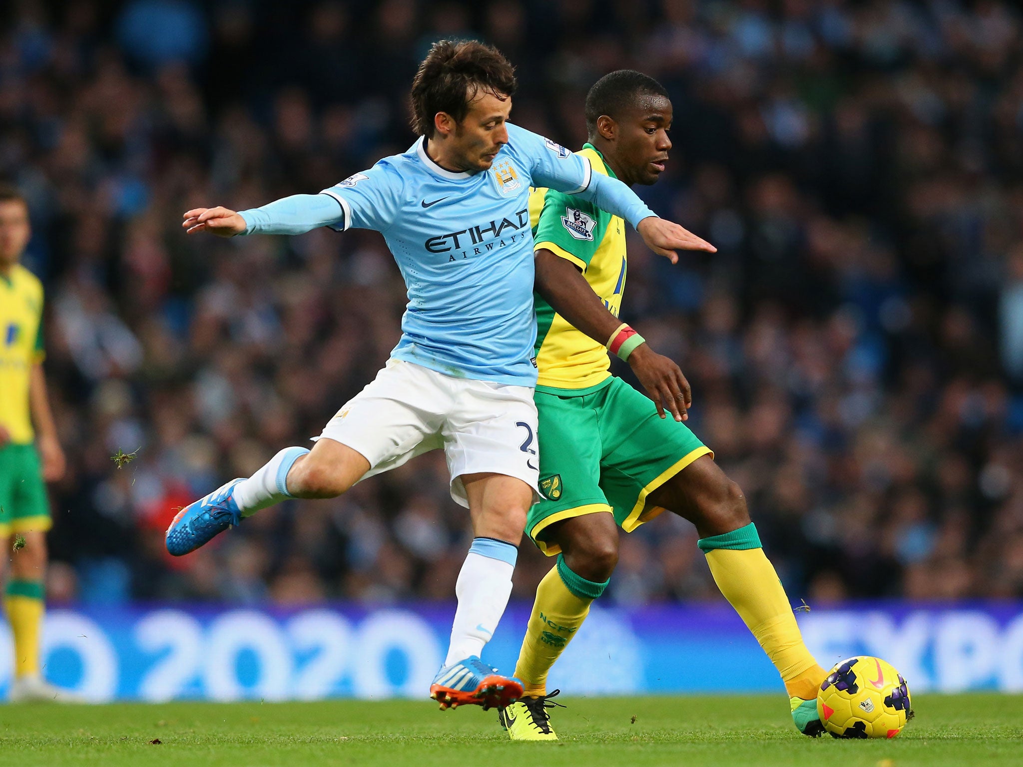 David Silva, left, tries to get beyond Norwich defender Sébastien Bassong