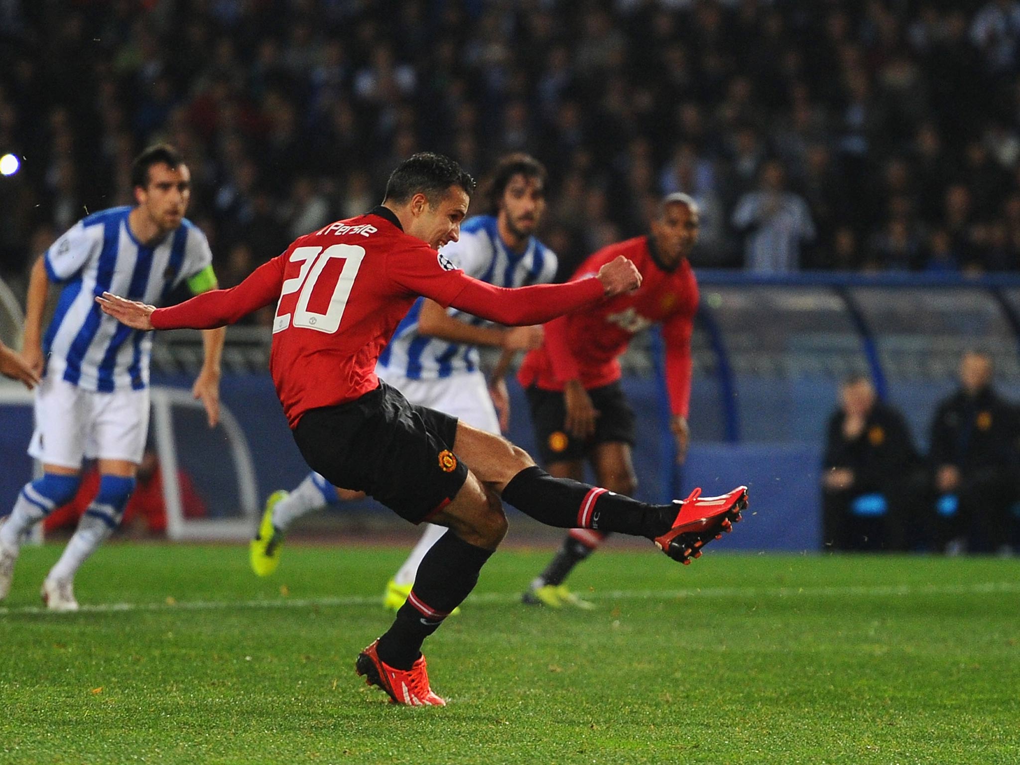 Ashley Young watches on as Robin van Persie hits the post from the penalty spot