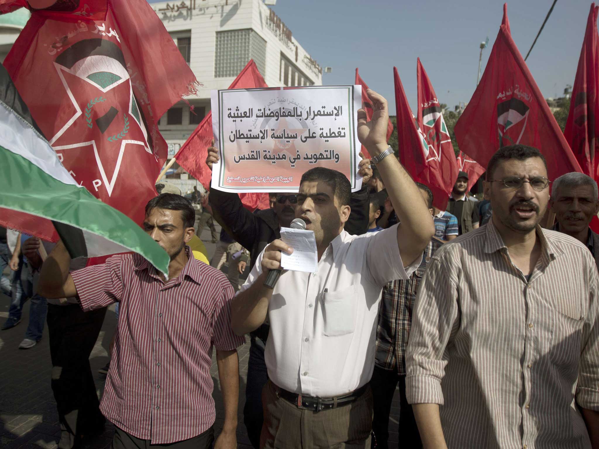 A Palestinian man leads a demonstration against the visit of John Kerry to Palestine