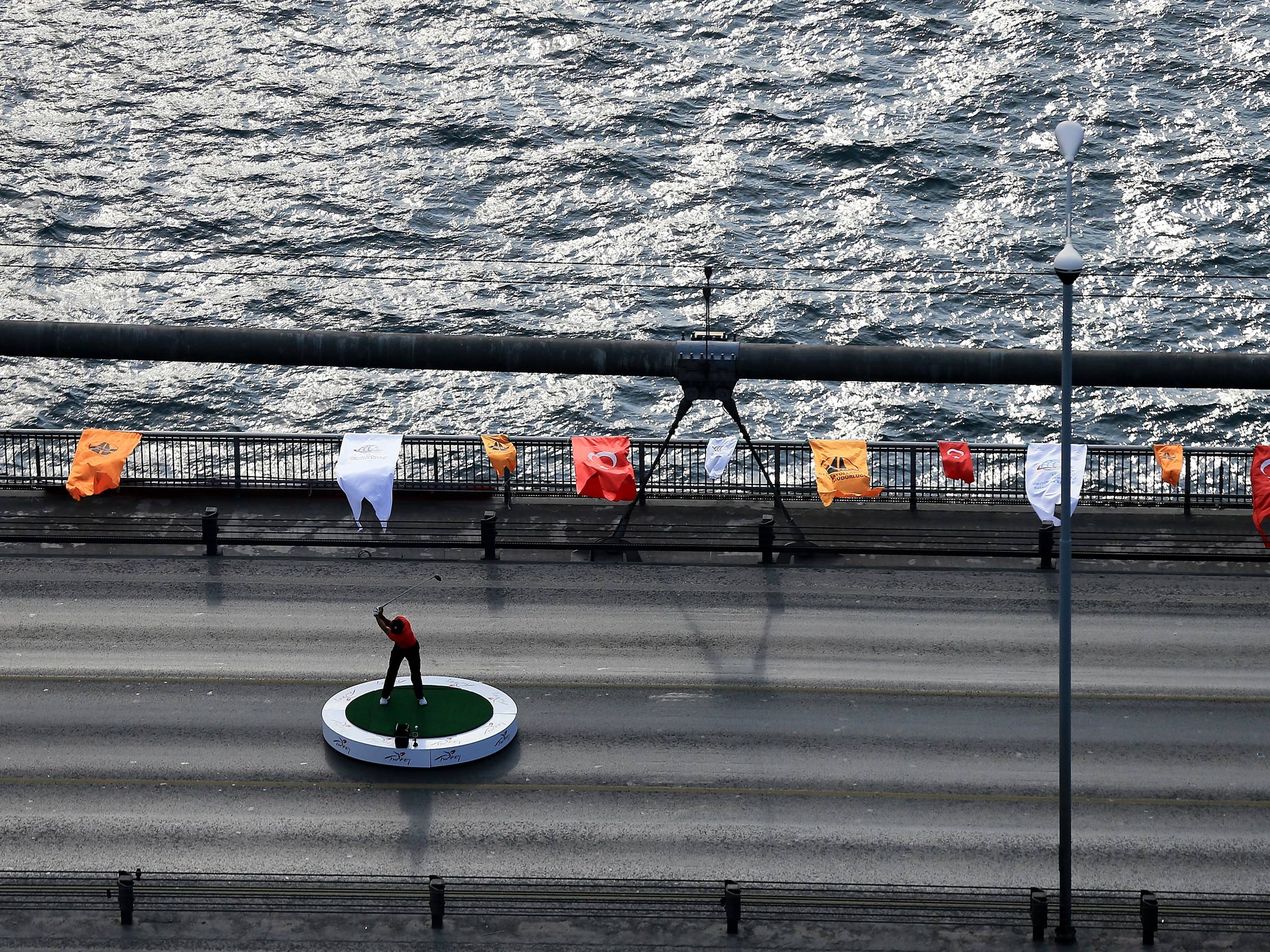 Tiger Woods makes history as he hits the first golf shots from East to West on Istanbul's iconic Bosphorus Bridge