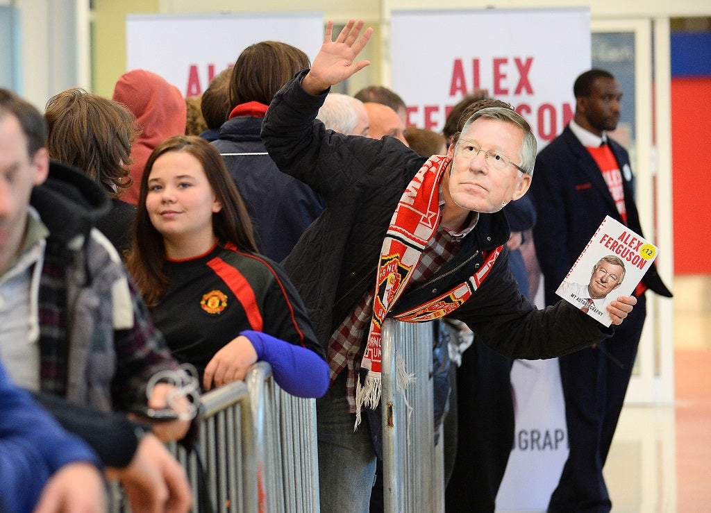 An enthusiastic fan queues up at a signing of Sir Alex Ferguson's autobiography in Manchester