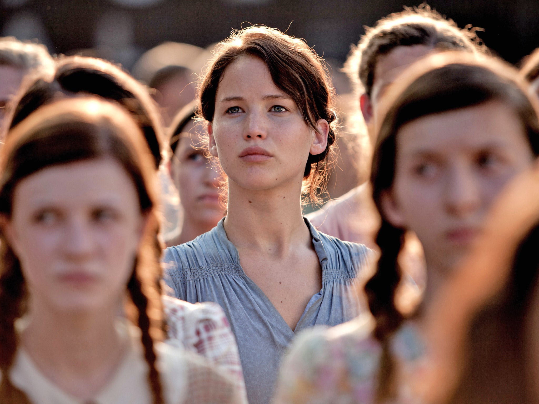 Jennifer Lawrence, here pictured as Katniss Everdeen in The Hunger Games, works like a 'slave' according to Russell