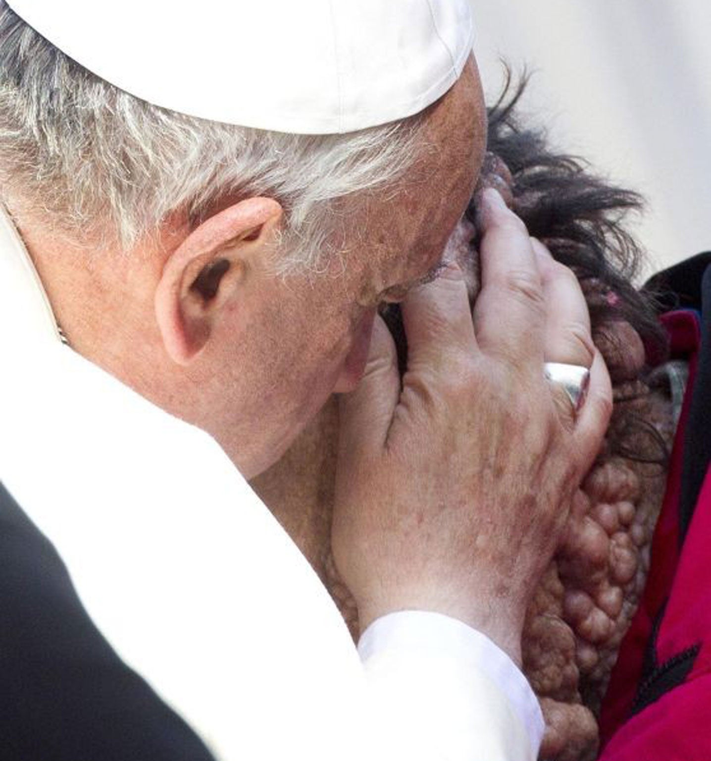 Pope Francis caresses a sick person in Saint Peter's Square