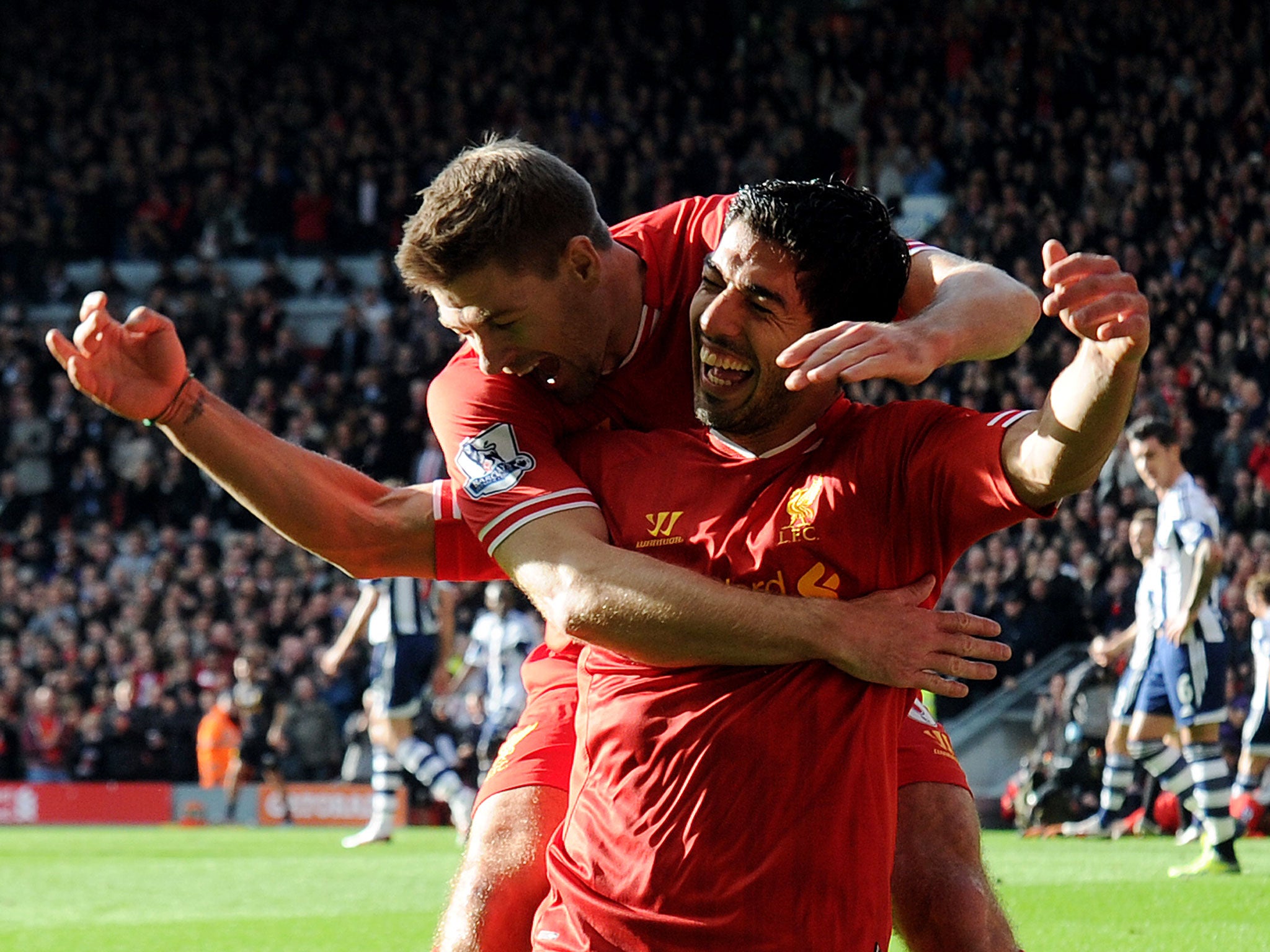 Steven Gerrard is hoping success this season will convince Luis Suarez to stay with Liverpool