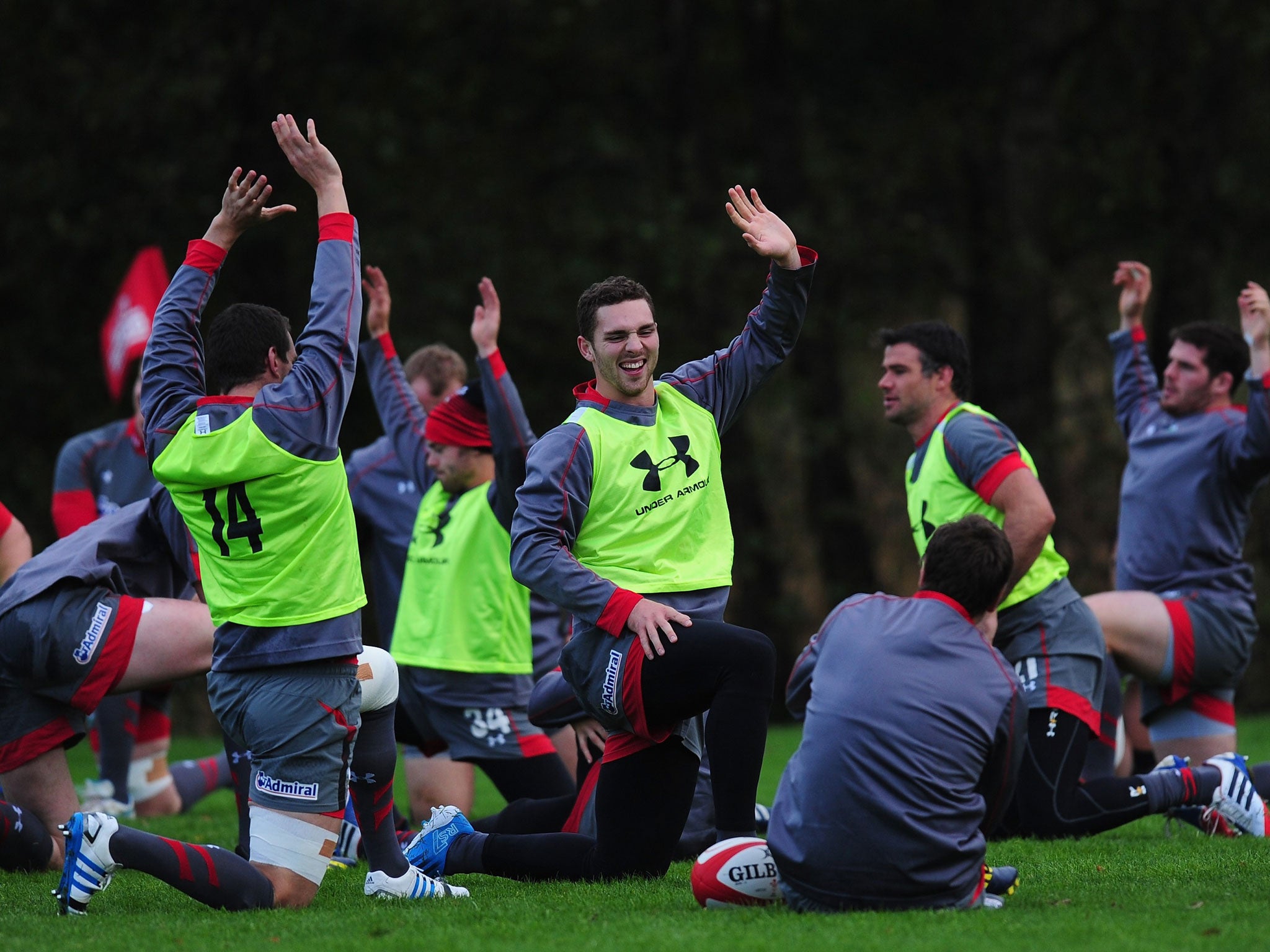 George North (centre) shares a joke with his team-mates during the warm-up in training