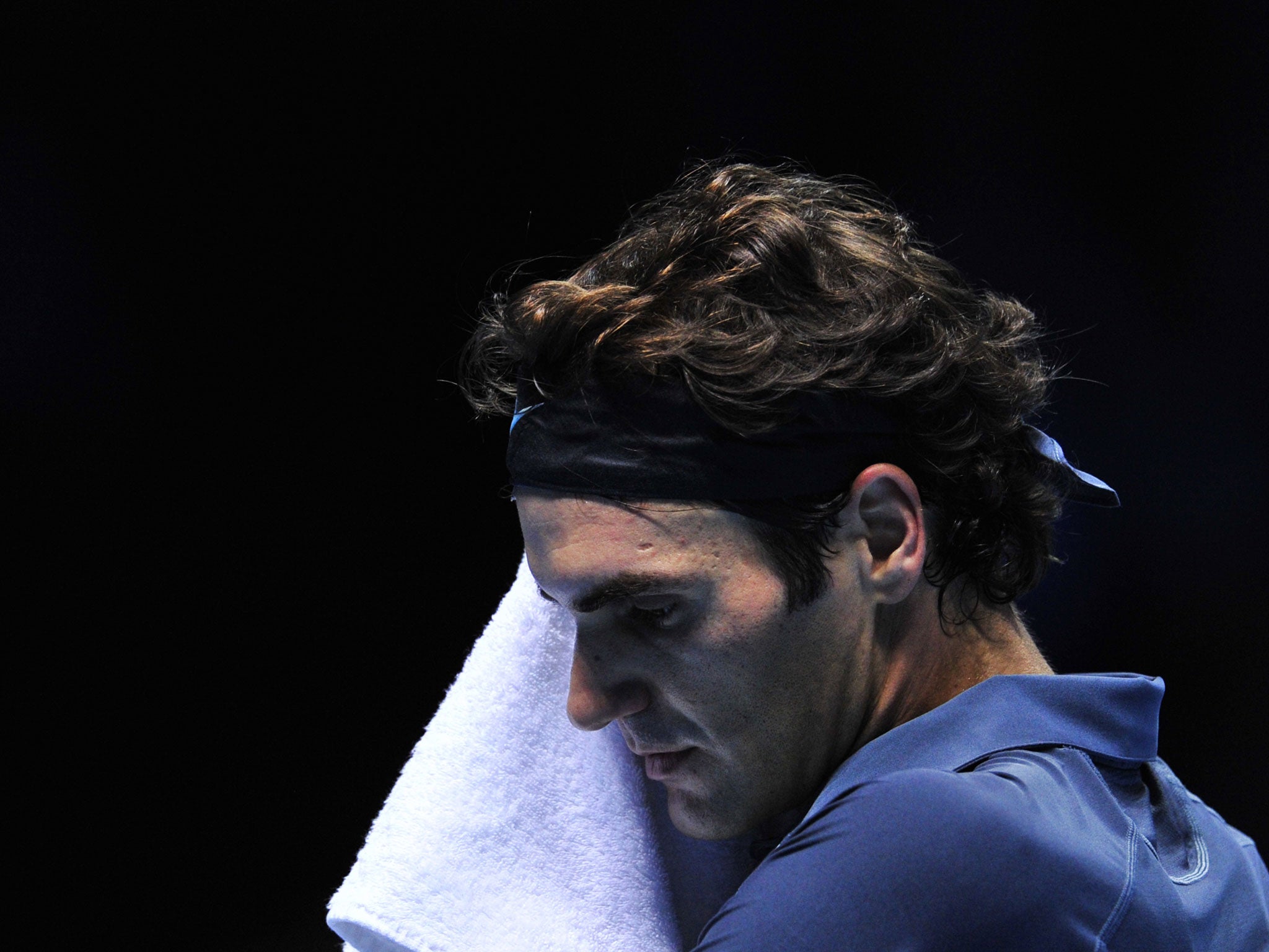 Federer sits between games against Richard Gasquet during their group B singles match in the round robin stage on the fourth day of the ATP World Tour Finals tennis tournament in London