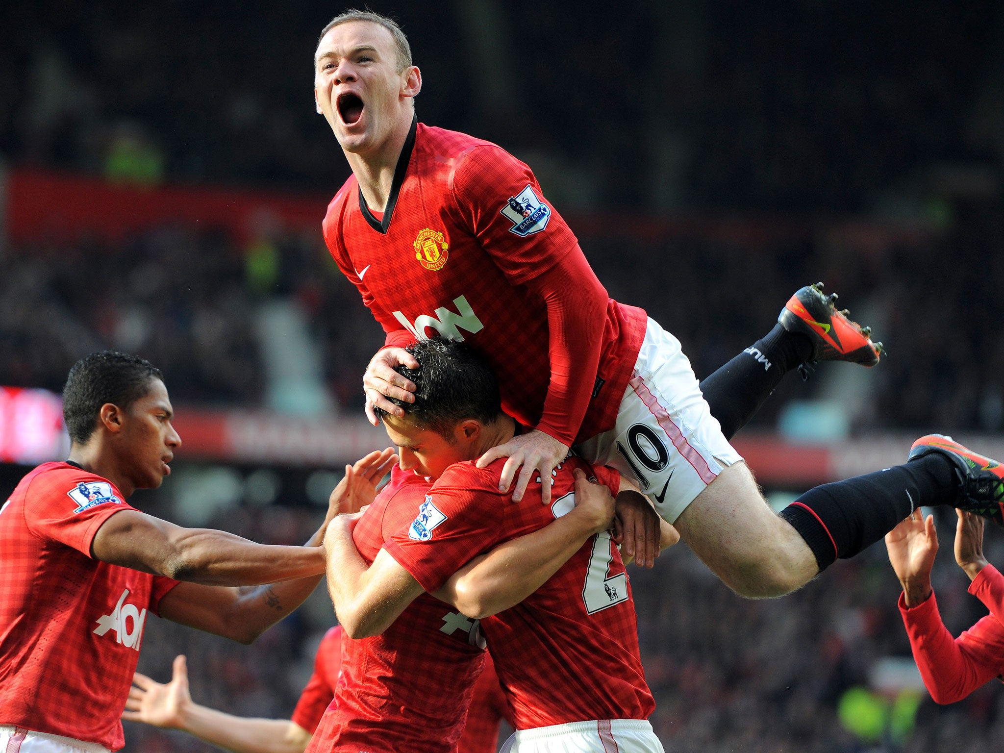 Wayne Rooney celebrates Robin van Persie's opening goal in the 2-1 win over Arsenal in November 2012