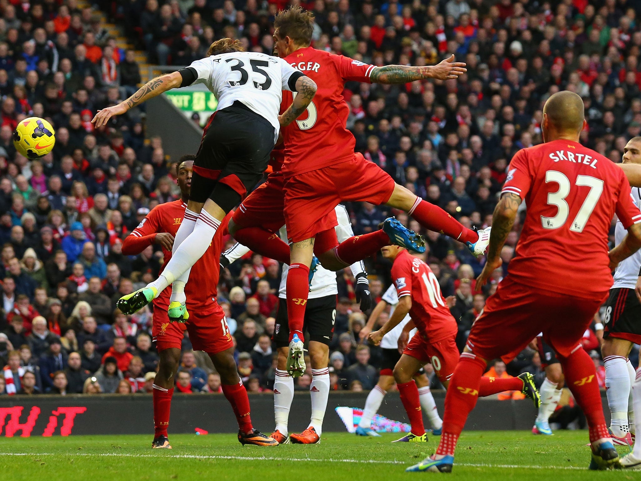 Luis Suarez of Liverpool scores the opening goal during the Barclays Premier League match between Liverpool and Fulham at Anfield