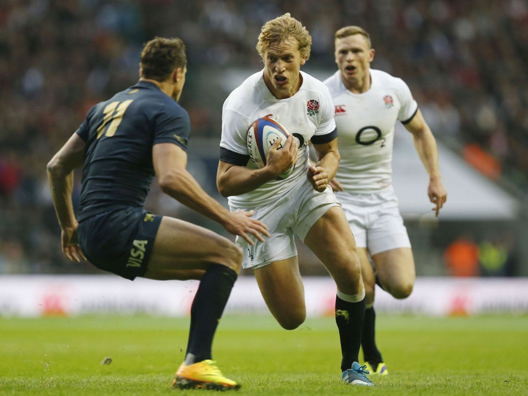 Billy Twelvetrees, center, tries to get past Argentina's Juan Jose Imhoff, left, during their autumn international rugby match at Twickenham