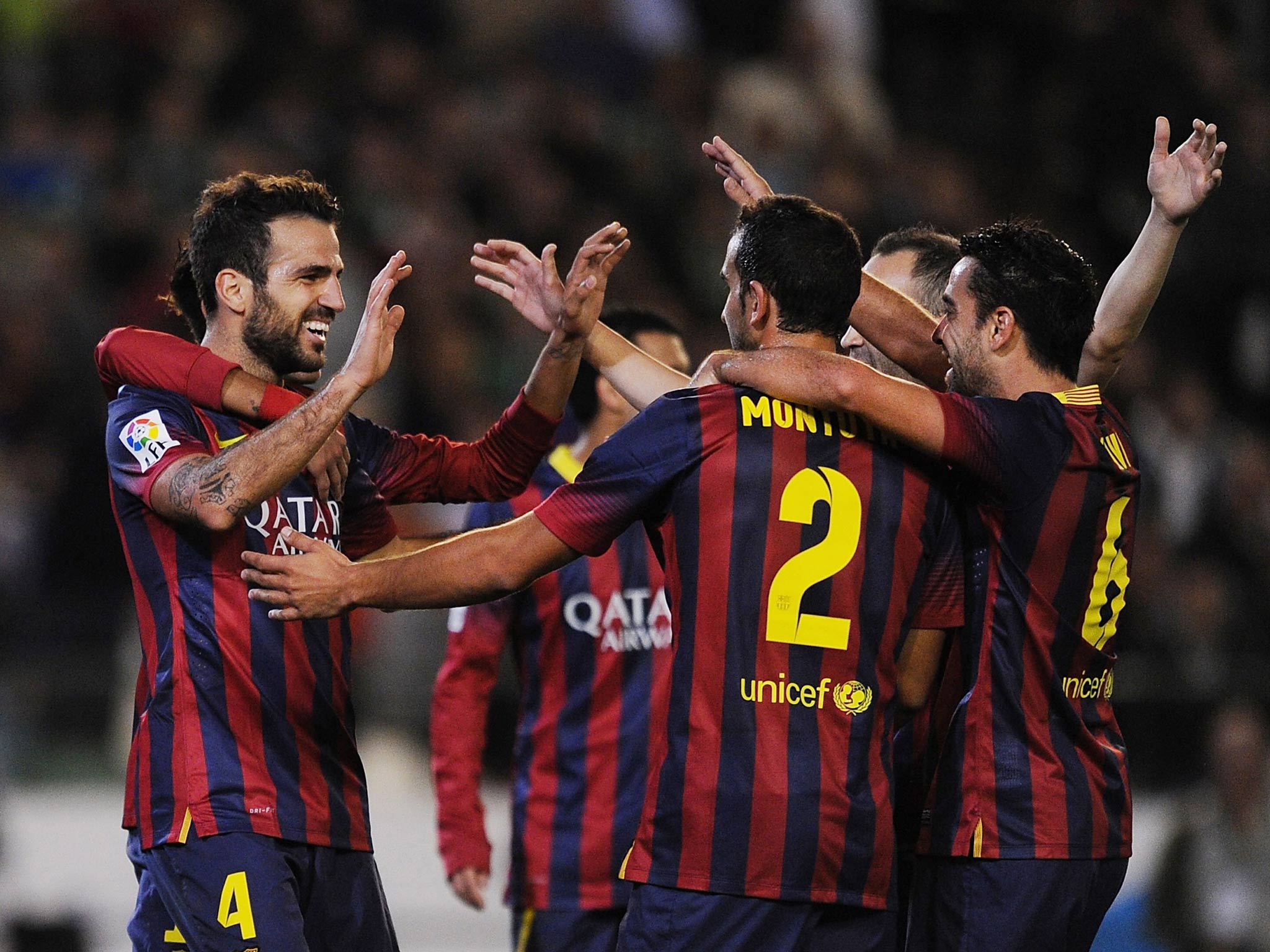 Barcelona players, including Cesc Fabregas, celebrate a goal