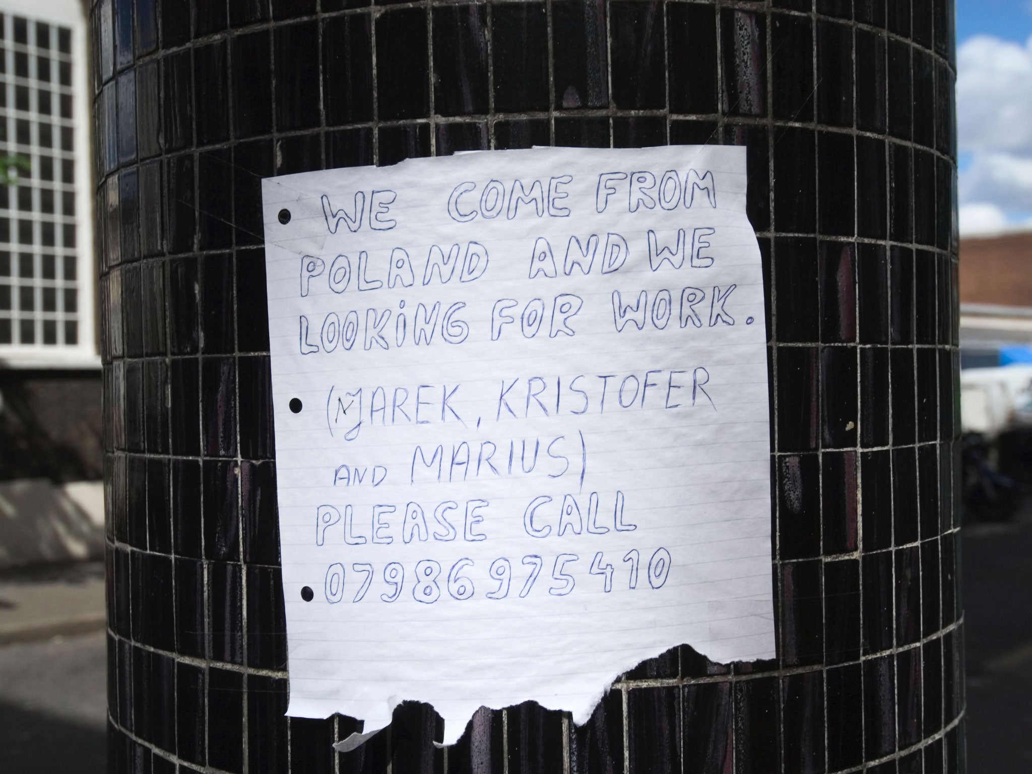 A Polish builder advertises for work on a makeshift sign