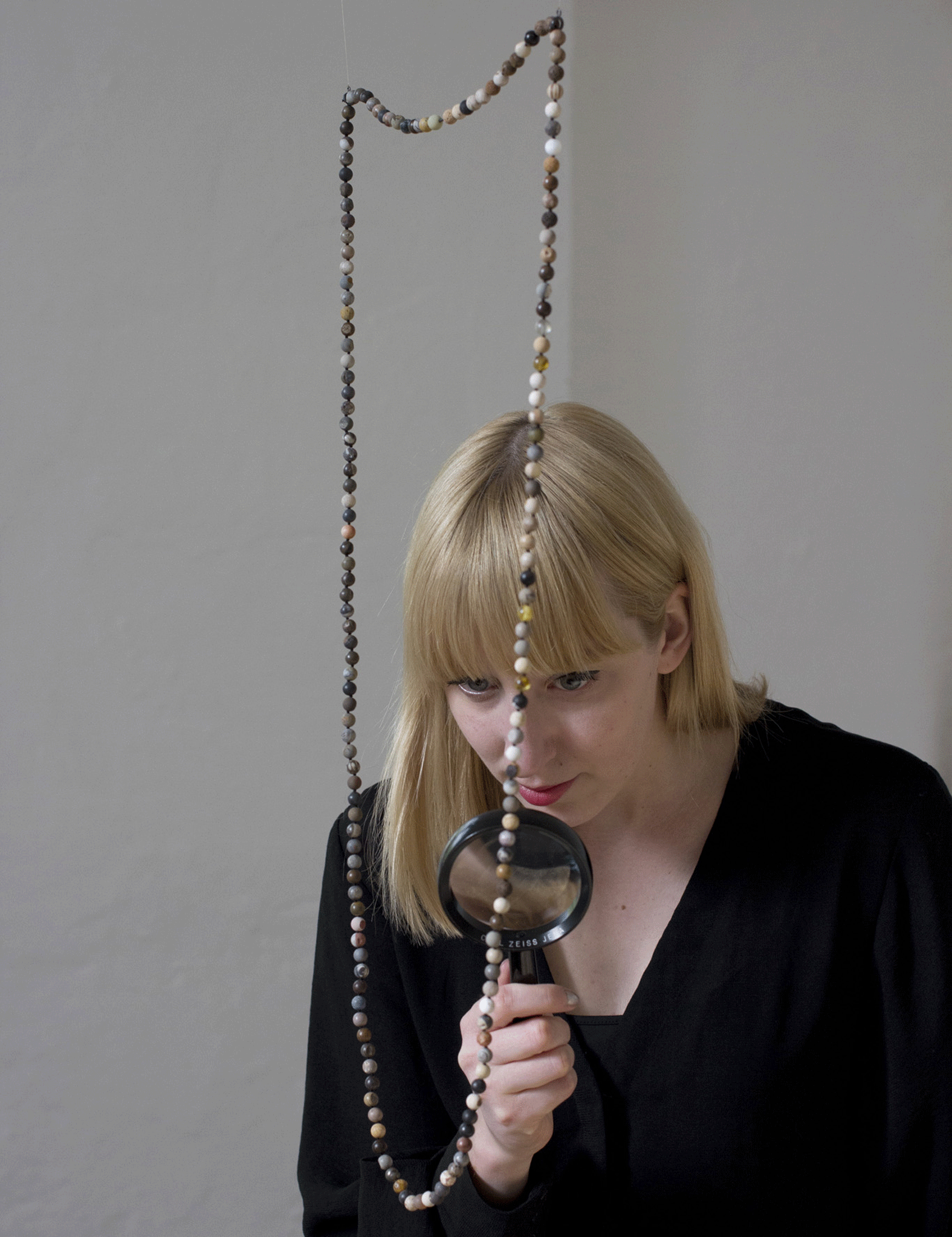 Carved rounded fossils, some from 3.2 billion years ago, go on show as a necklace at the Wellcome collection