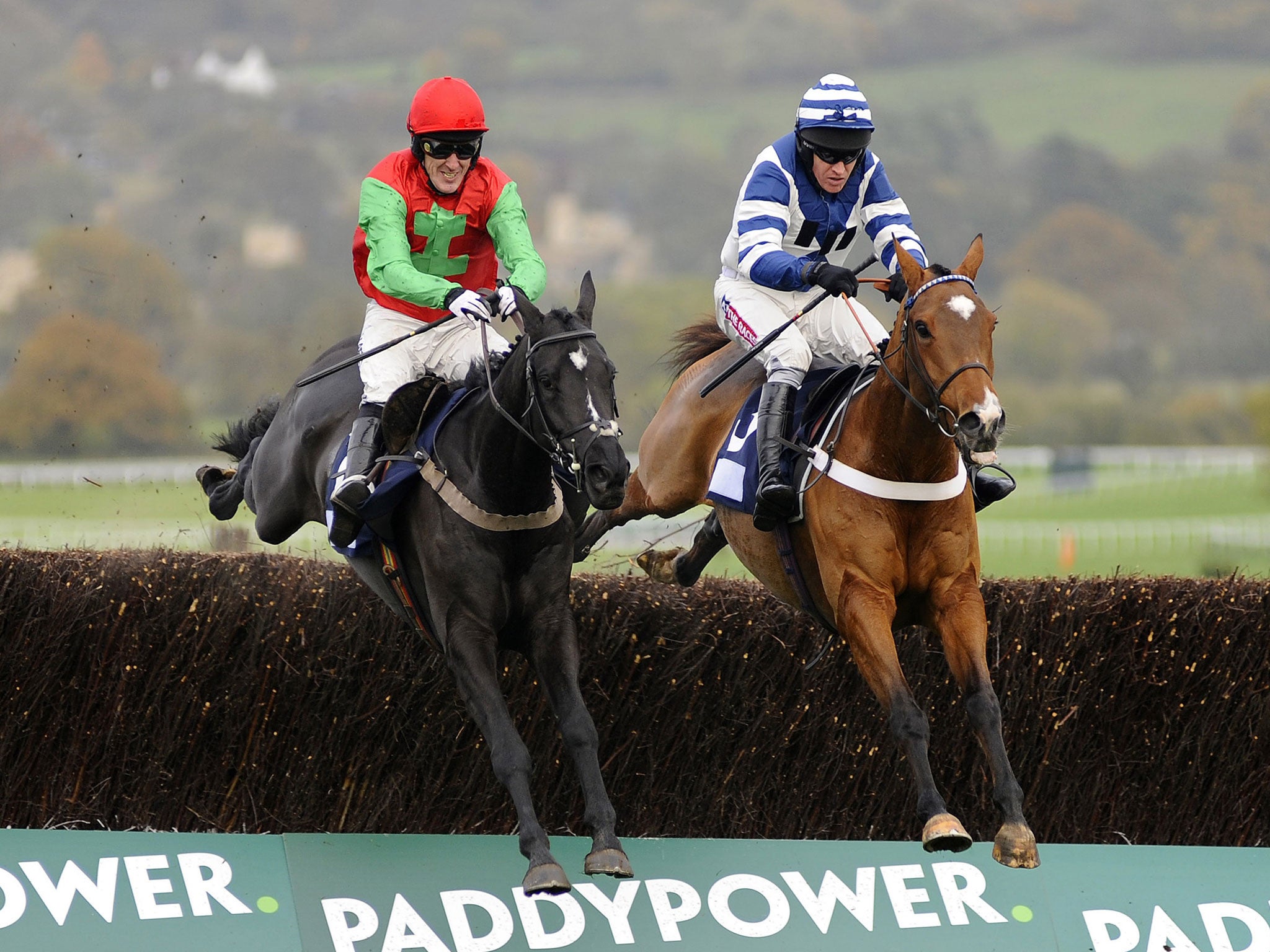 Taquin Du Seuil (left) en route to beating Oscar Whisky at Cheltenham yesterday