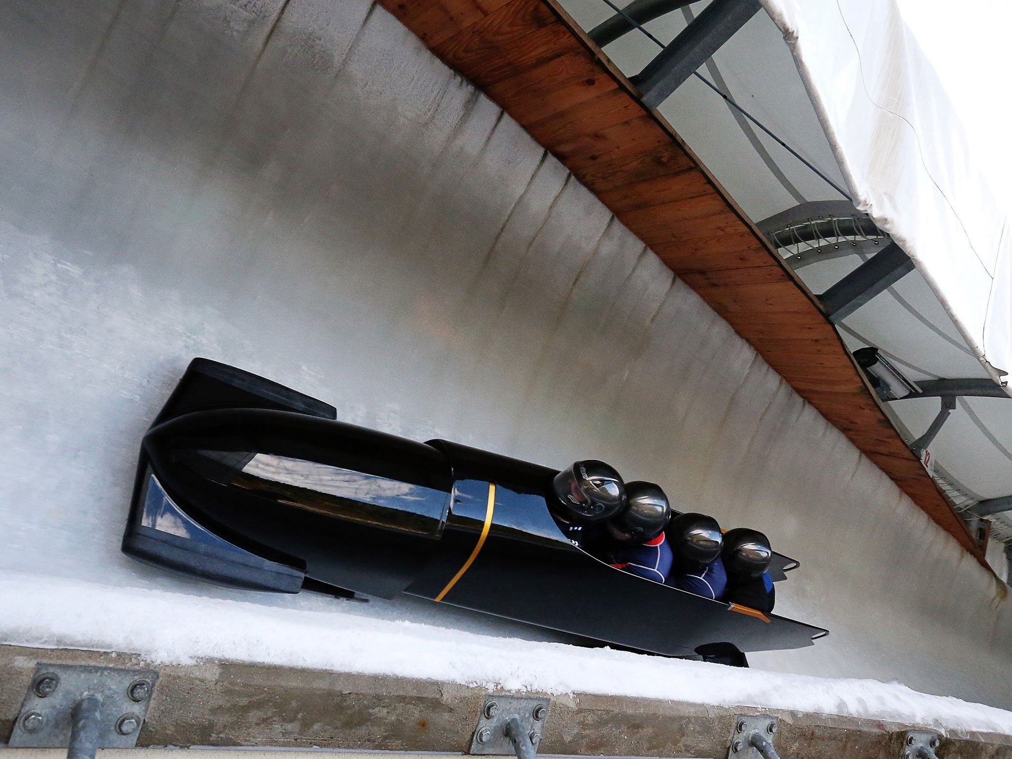 The GBR1 bobsleigh crew of John Jackson, Bruce Tasker, Stu Benson and Craig Pickering take a bend during a training run at La Plagne, France