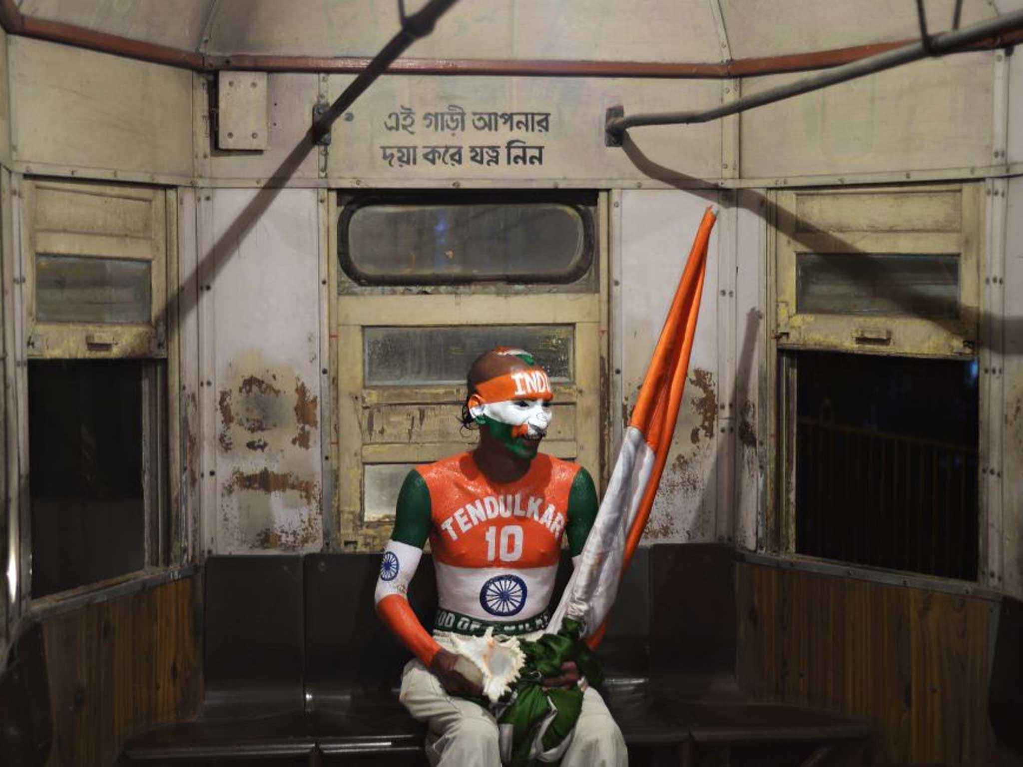 A cricket fan sits alone in his tram home