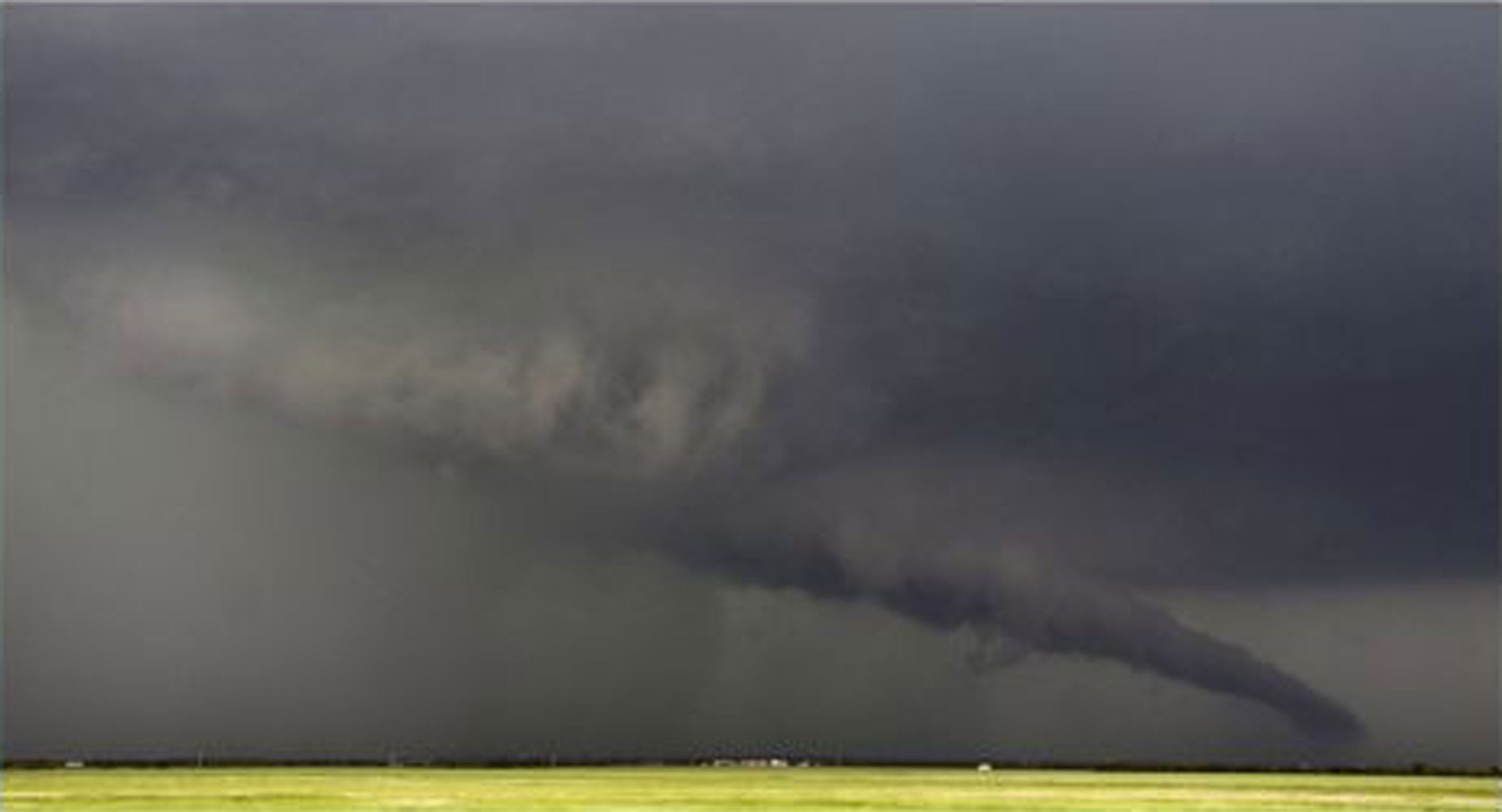 File: The funnel of a tornado touches down during a thunderstorm in May near South Haven, Oklahoma