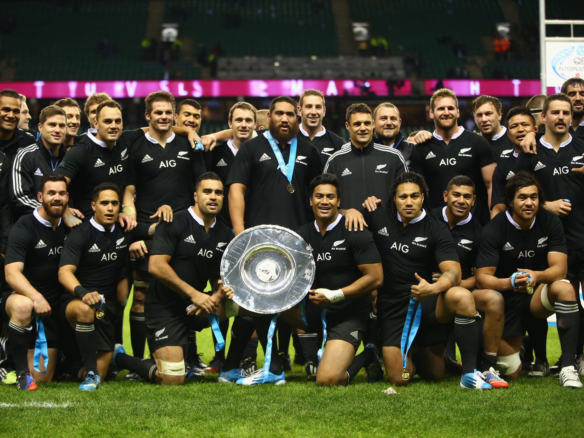 The All Blacks pose with the trophy after the QBE International match between England and New Zealand at Twickenham Stadium