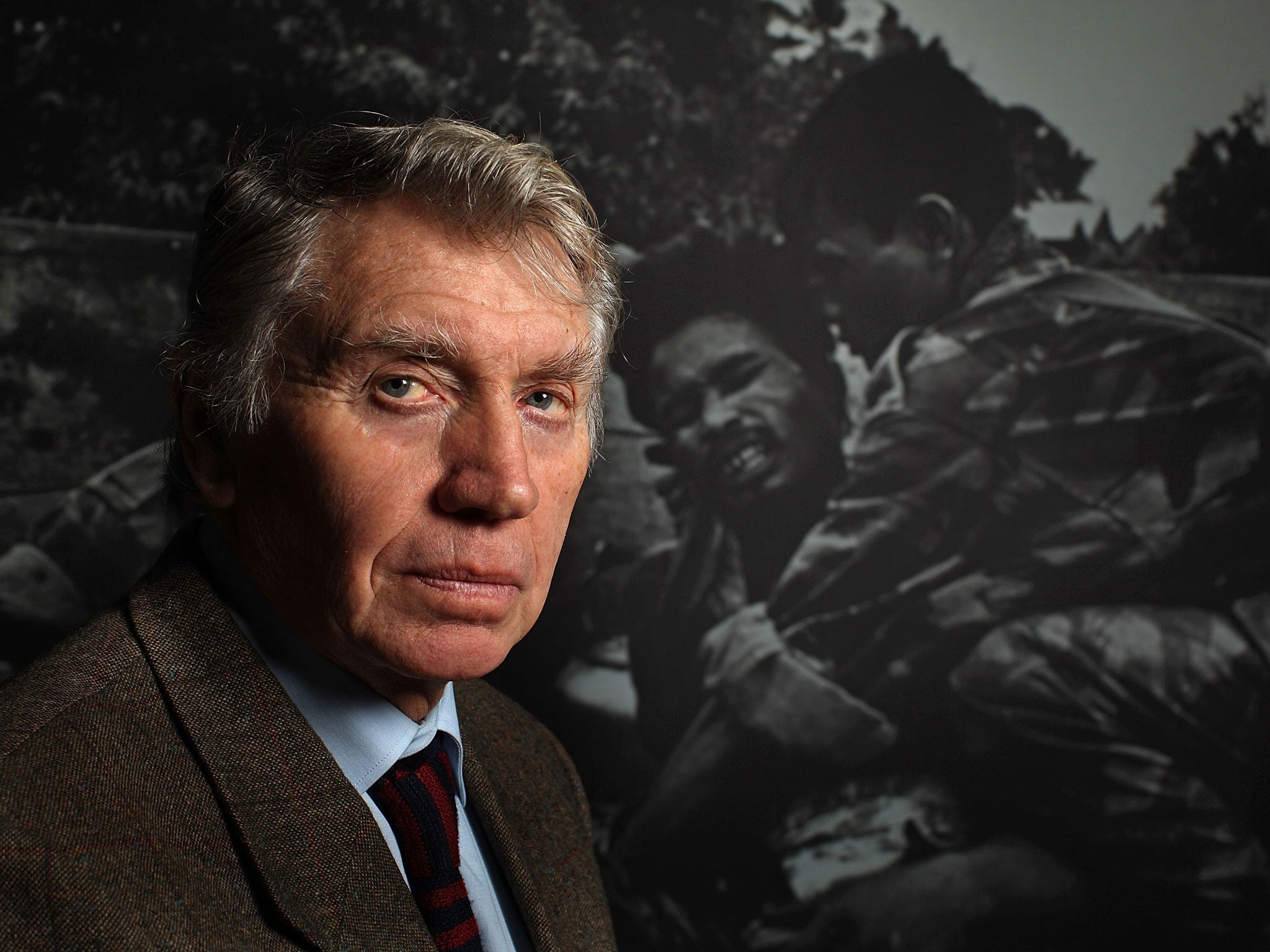 Acclaimed photographer Don McCullin posing next to one of his legendary images at the Imperial War Museum North (Getty)