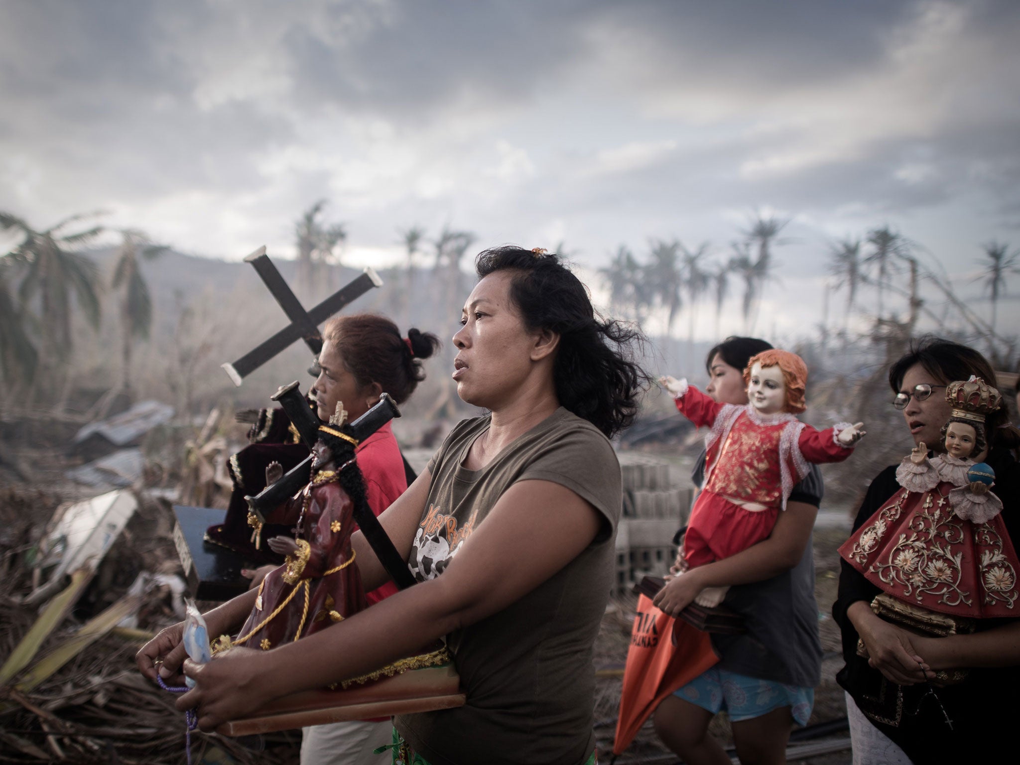 Survivors of Typhoon Haiyan salvage sacred statues on the devastated island of Leyte a week after the storm tore through the Philippines