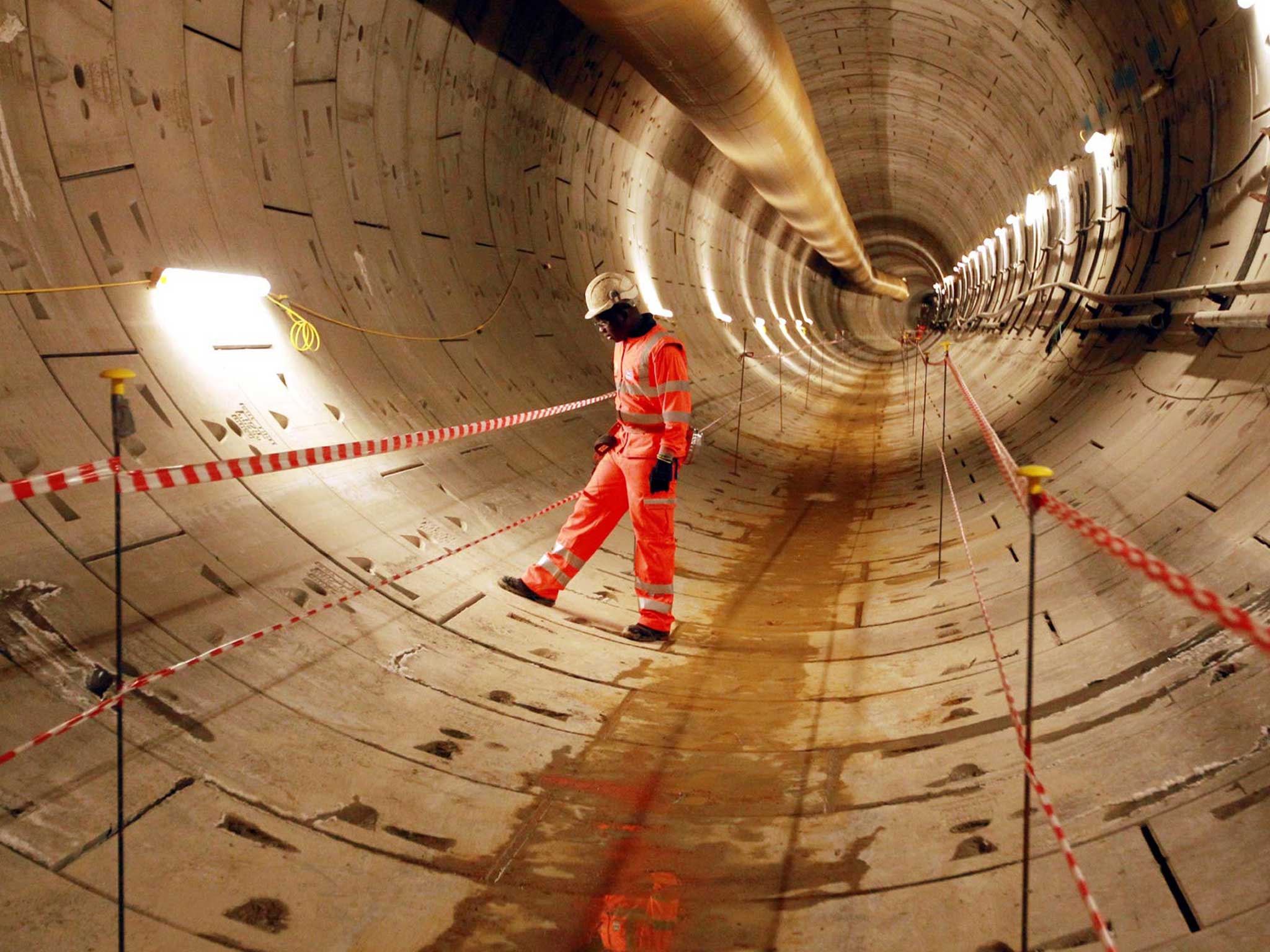 Crossrail worker Sam Agyeman inspects the first completed section of Crossrail tunnel