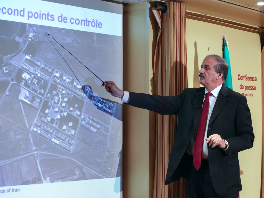 Mehdi Abrichamtchi (C), Peace and Security Committee Chairman of the National Council of Resistance of Iran (NCRI) shows to journalists a secret nuclear site in Iran during a press conference on November 18, 2013 in Paris.