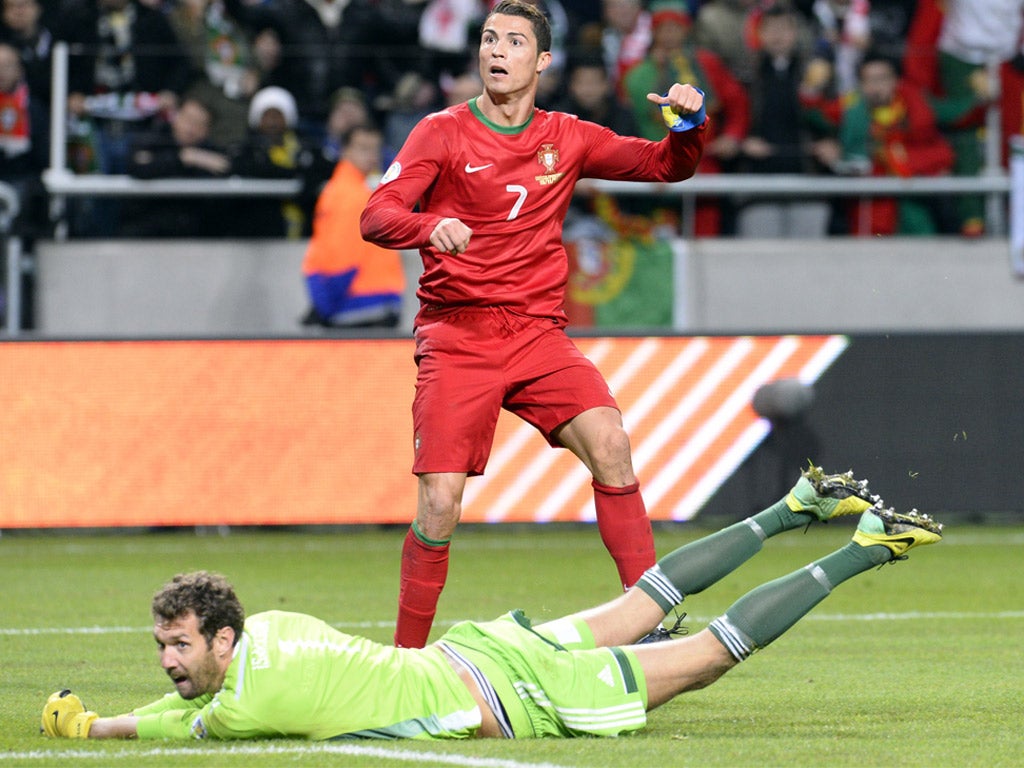 Cristiano Ronaldo hits the second goal of his hat-trick for Portugal (Getty)