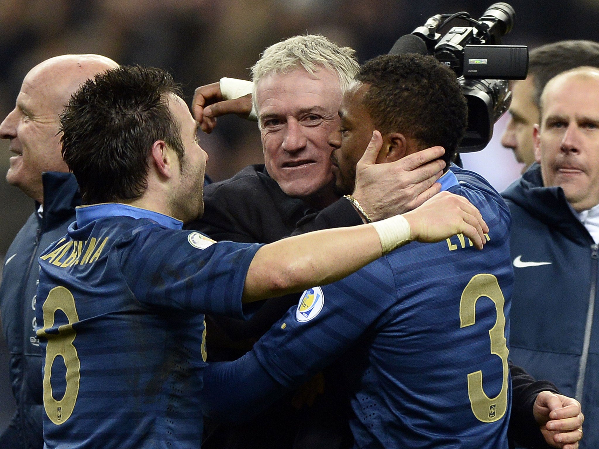 Didier Deschamps (centre) celebrates with Mathieu Valbuena (left) and Patrice Evra