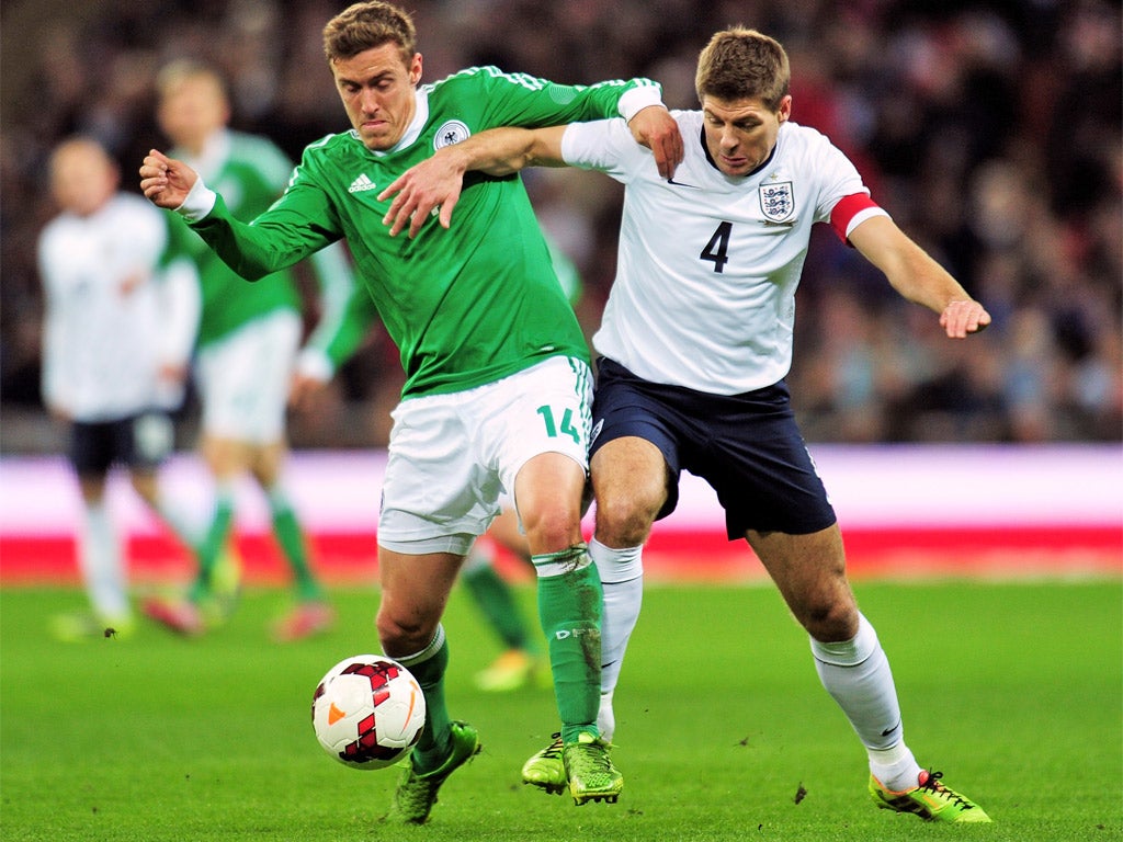 Steven Gerrard tangles with Germany’s Max Kruse