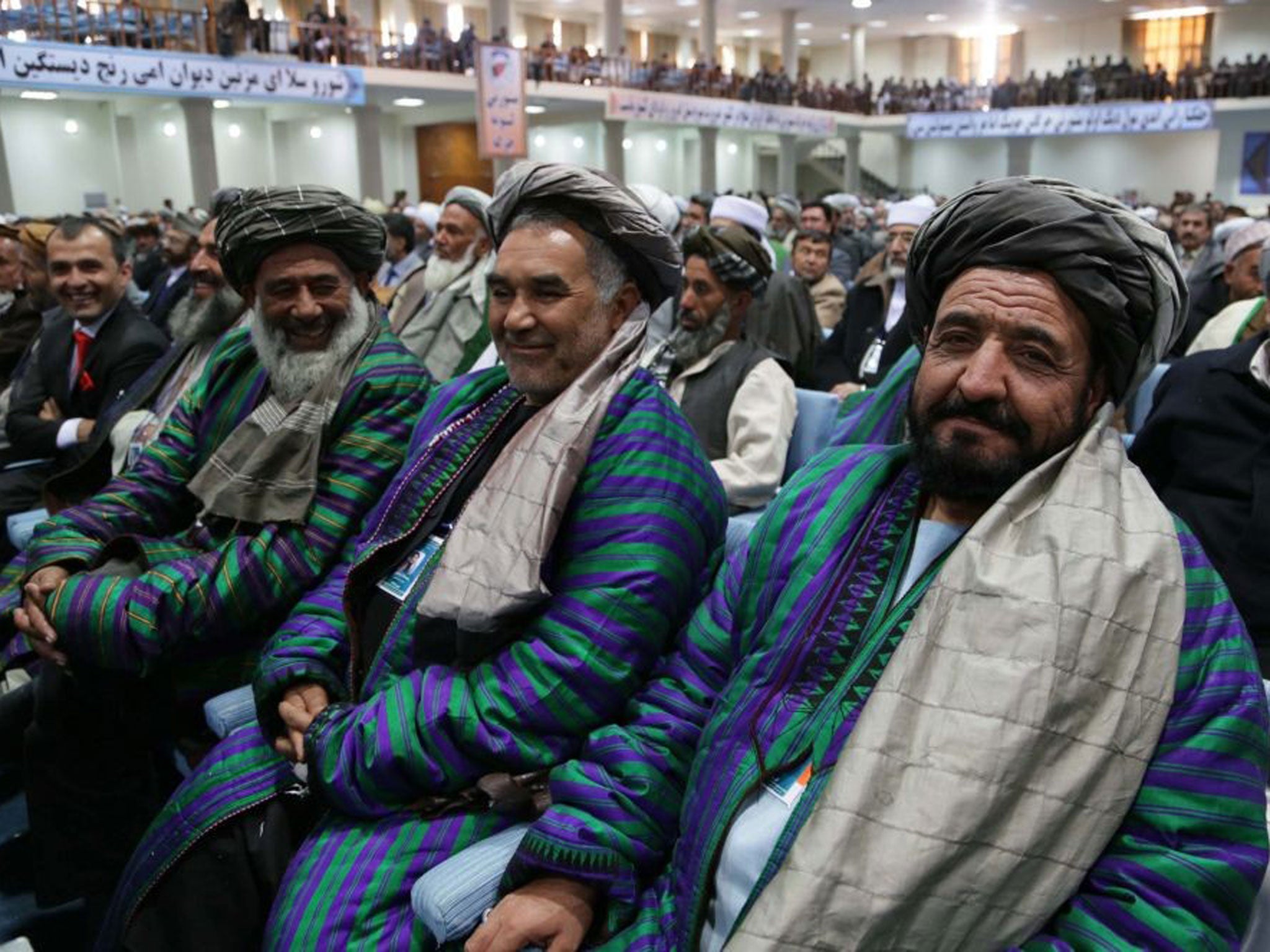 Afghan delegates listen to a speech of Afghan President Hamid Karzai during the Loya Jirga in Kabul