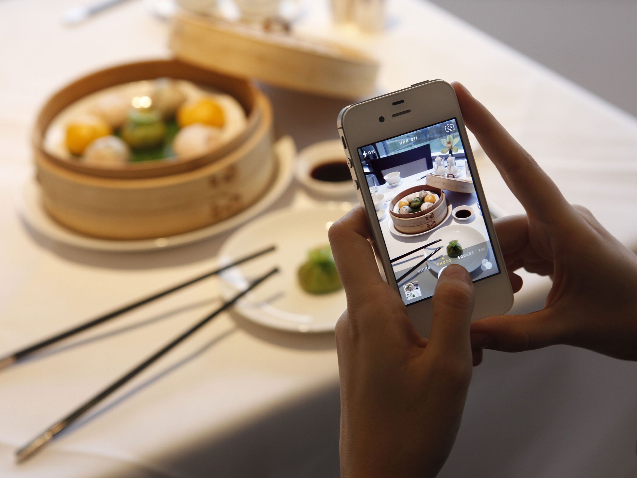 Food to share: diners take pictures of their meals at top restaurants to share on social media as a matter of course, as here at the Min Jiang restaurant, Royal Garden Hotel, in Kensington, London