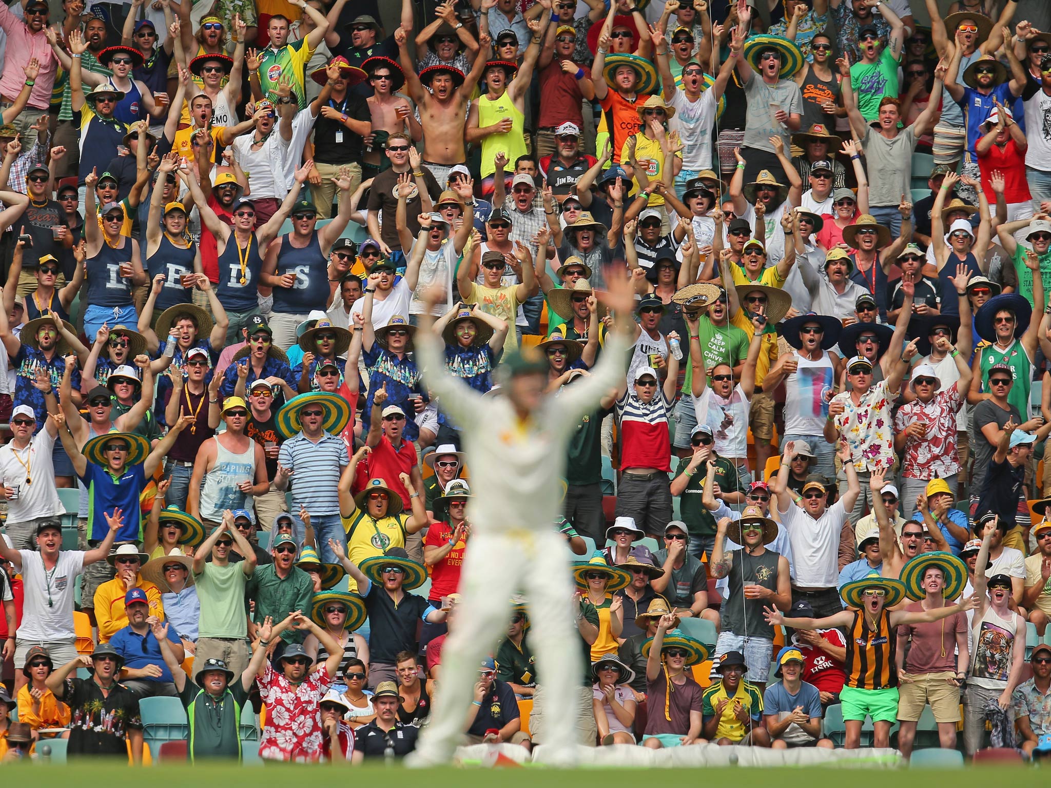 The crowd celebrates after Steven Smith (C) of Australia took a catch to dismiss Ian Bell of England during day two of the First Ashes Test
