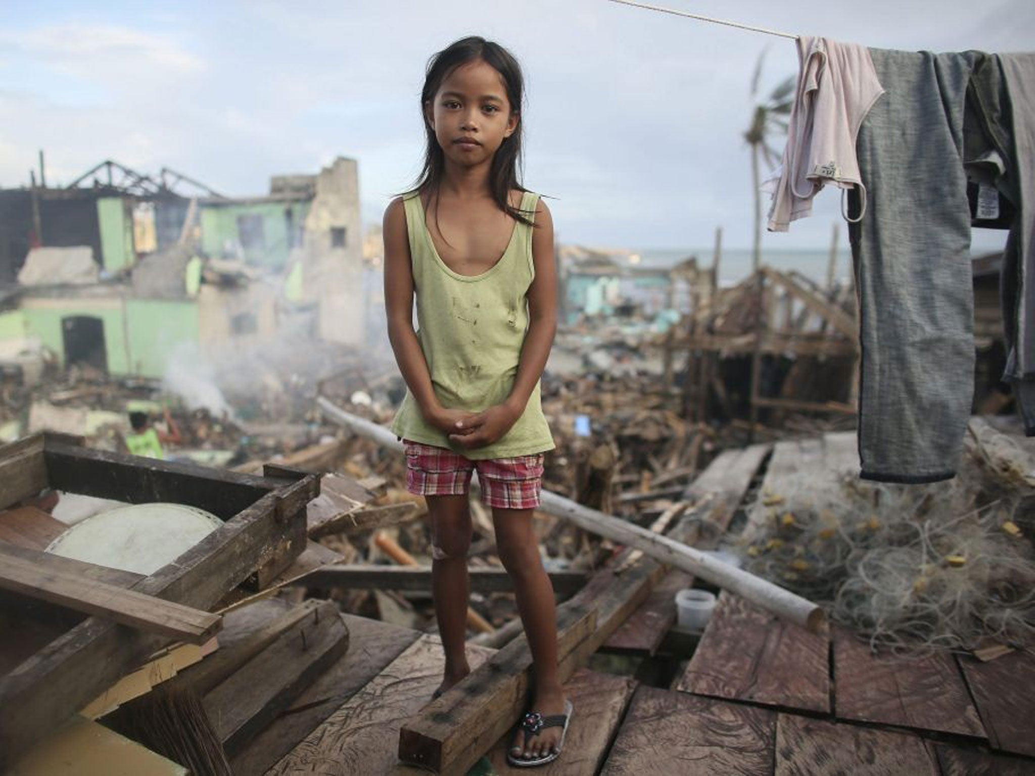 Nine year old Filipino girl Janine Eder survived the storm by fleeing with her family to the village of Lewaan which had a school in which they could shelter. They have now returned to rebuild their house
