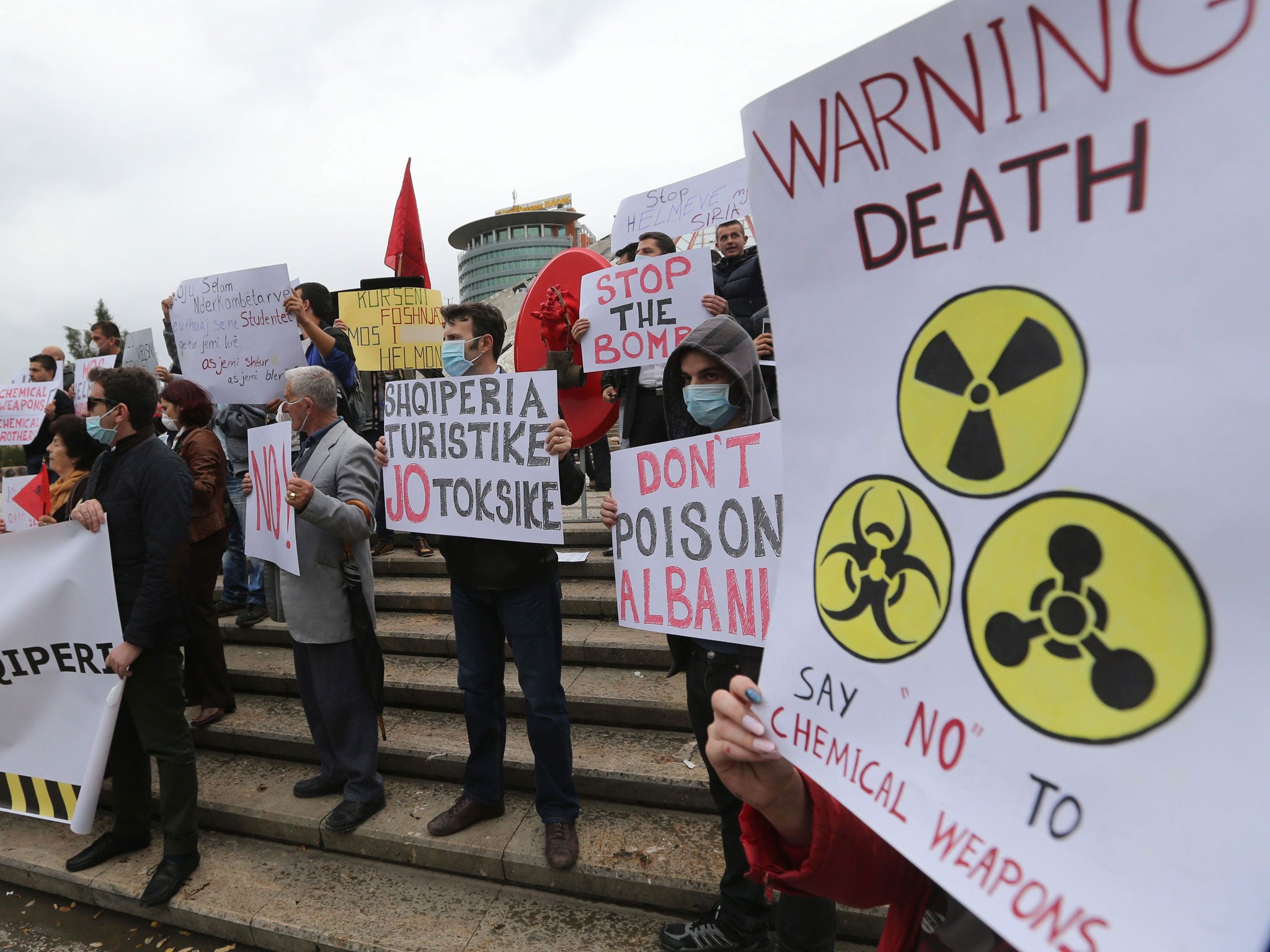 Albanian citizens hold placards during a protest against chemical weapons in front of Albanian Prime Minister's office in Tirana - the country came close to receiving the chemicals