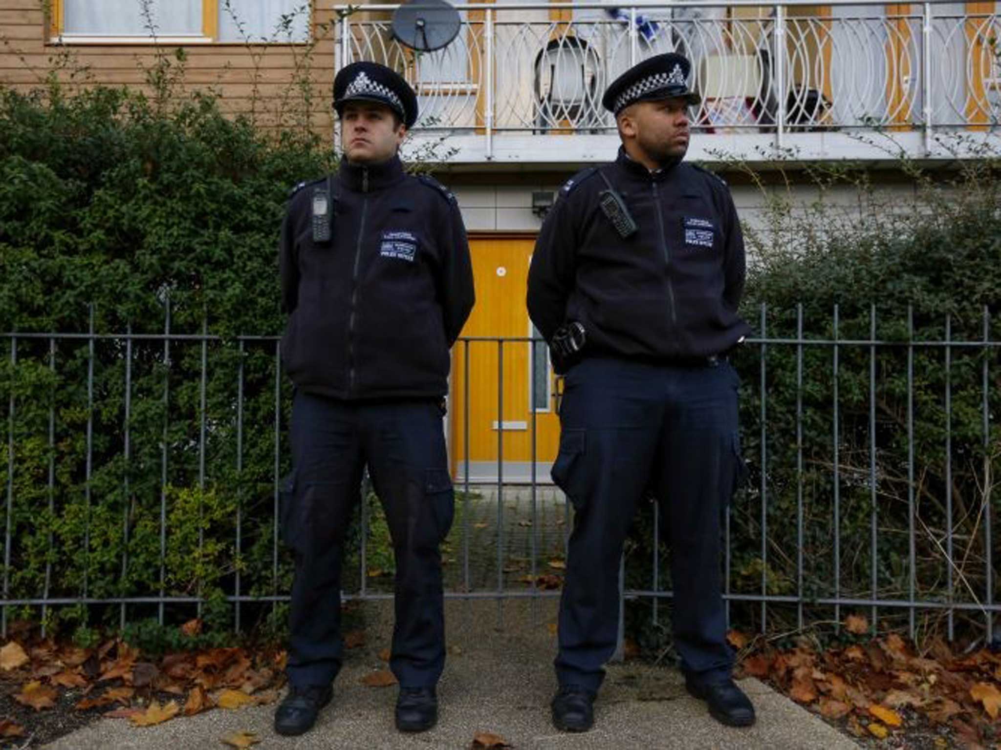 Police on guard outside the Peckford Place property yesterday