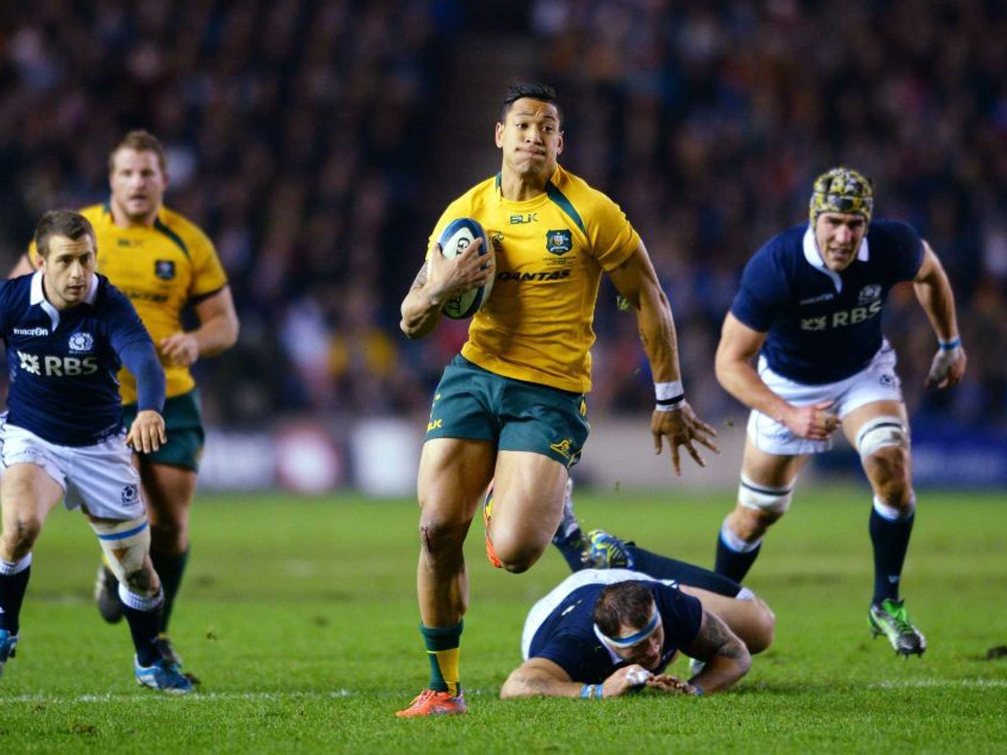 Flying High: Israel Folau breaks away from Moray Low and fellow defenders to score his try