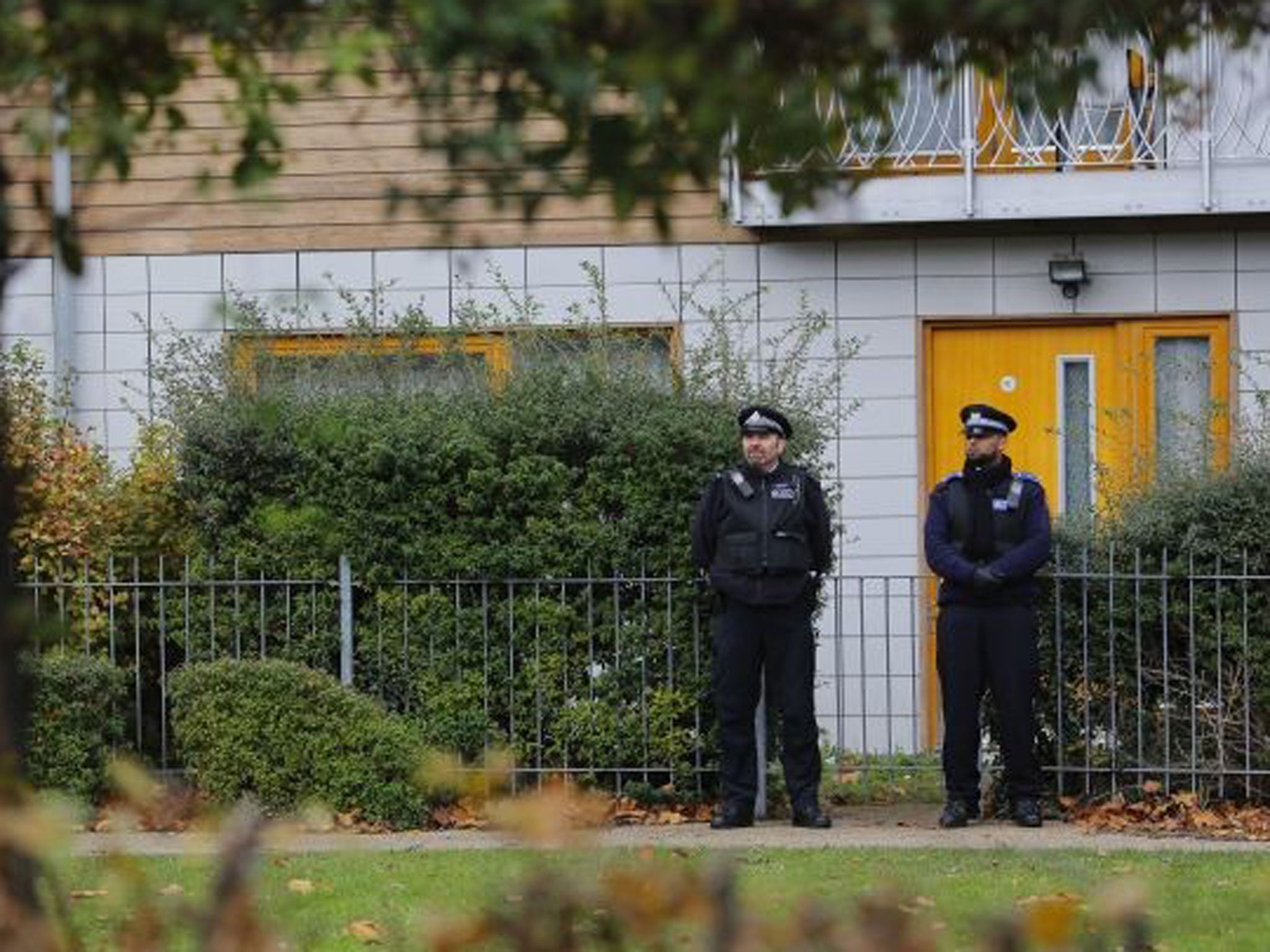 Police guard the flats being investigated in connection with an alleged slavery case