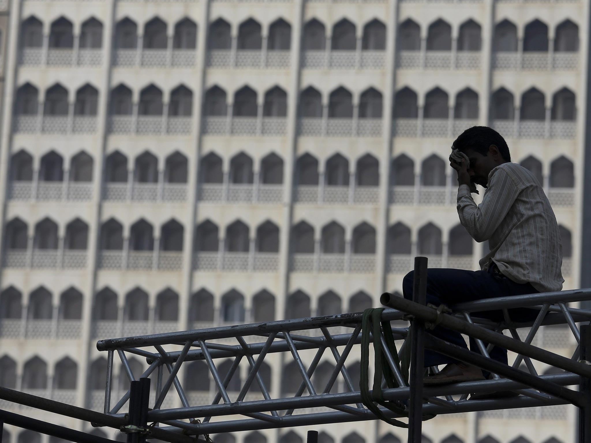 An Indian labourer erects a stage in front of the Taj Mahal hotel. Unskilled manual labourers are considered some of the country's most impoverished workers