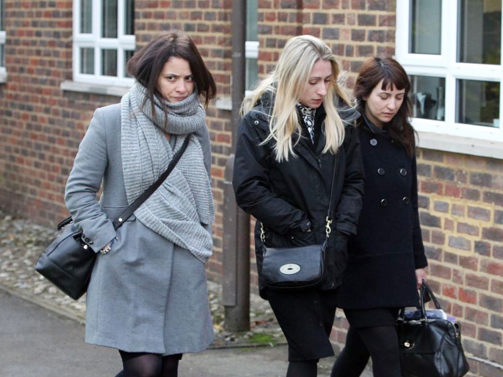 Former personal assistants to Charles Saatchi and Nigella Lawson, Elisabetta (left) and Francesca Grillo (right) arriving with an unidentified woman at Isleworth Crown Court in London