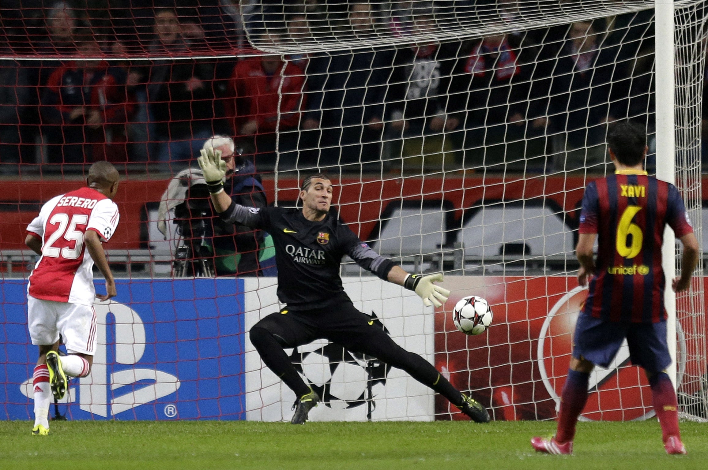 Ajax's Thulani Serero scores past Barcelona goalkeeper Jose Manuel Pinto