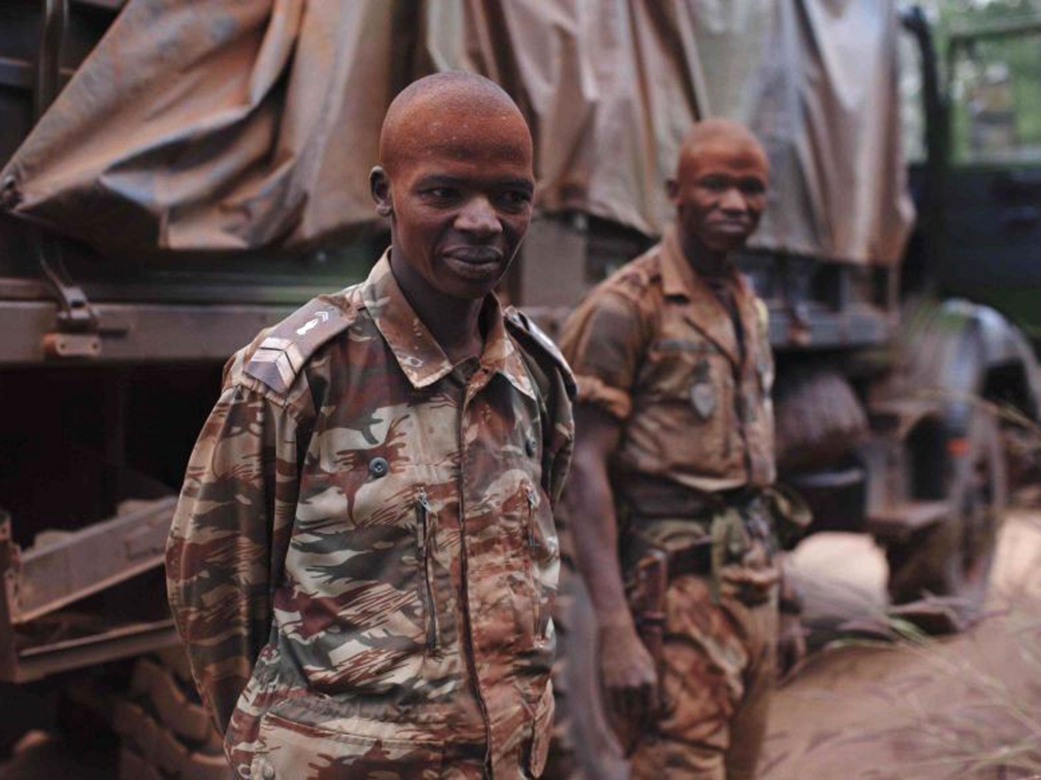 Congolese peacekeepers from the Multinational Force of Central Africa pose for a photograph as they stand covered in dust in Bossangoa, Central African Republic