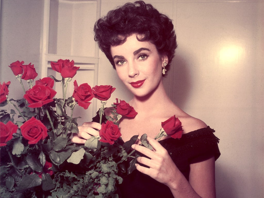 Strike a posy: Liz Taylor with first-night flowers