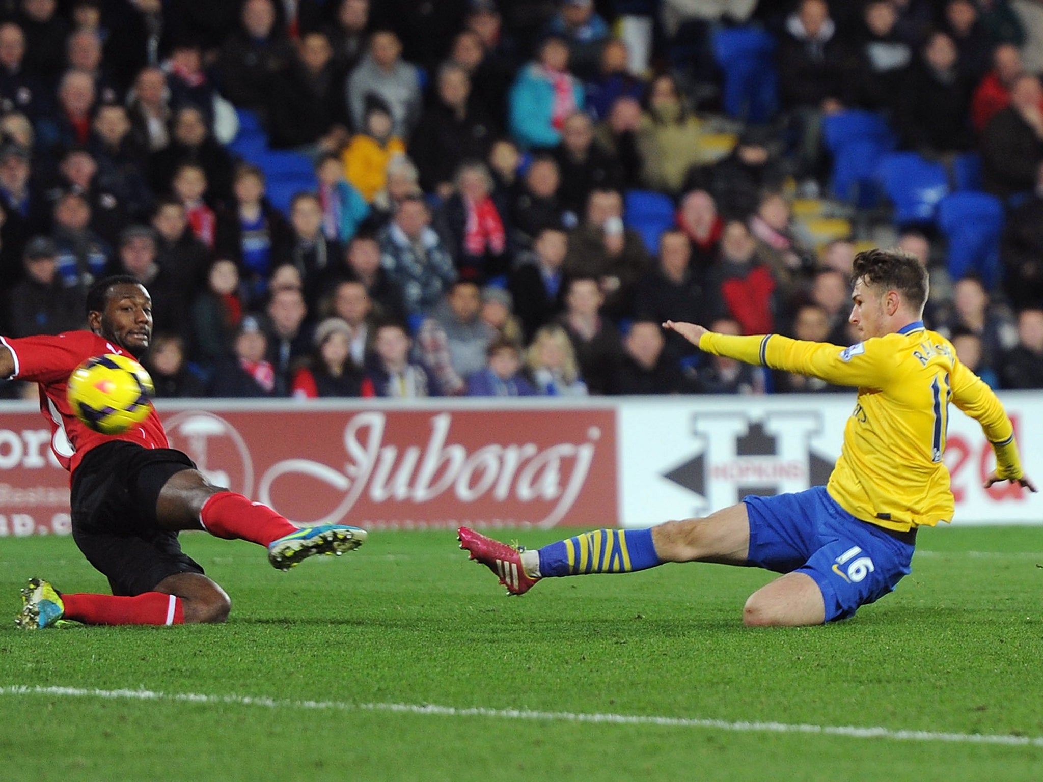 Aaron Ramsey slides in to score his second and Arsenal's third against Cardiff