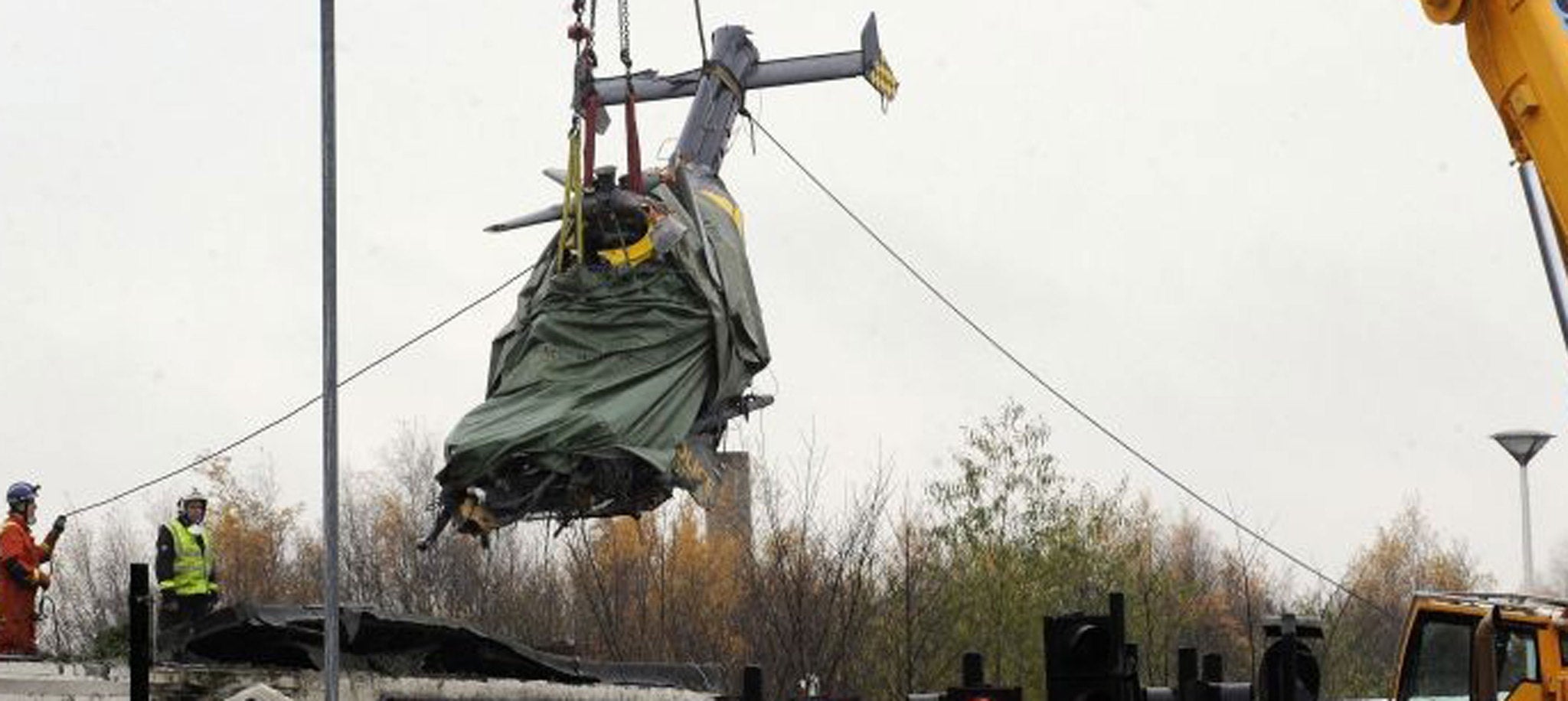 The police helicopter is lifted from The Clutha's wreckage