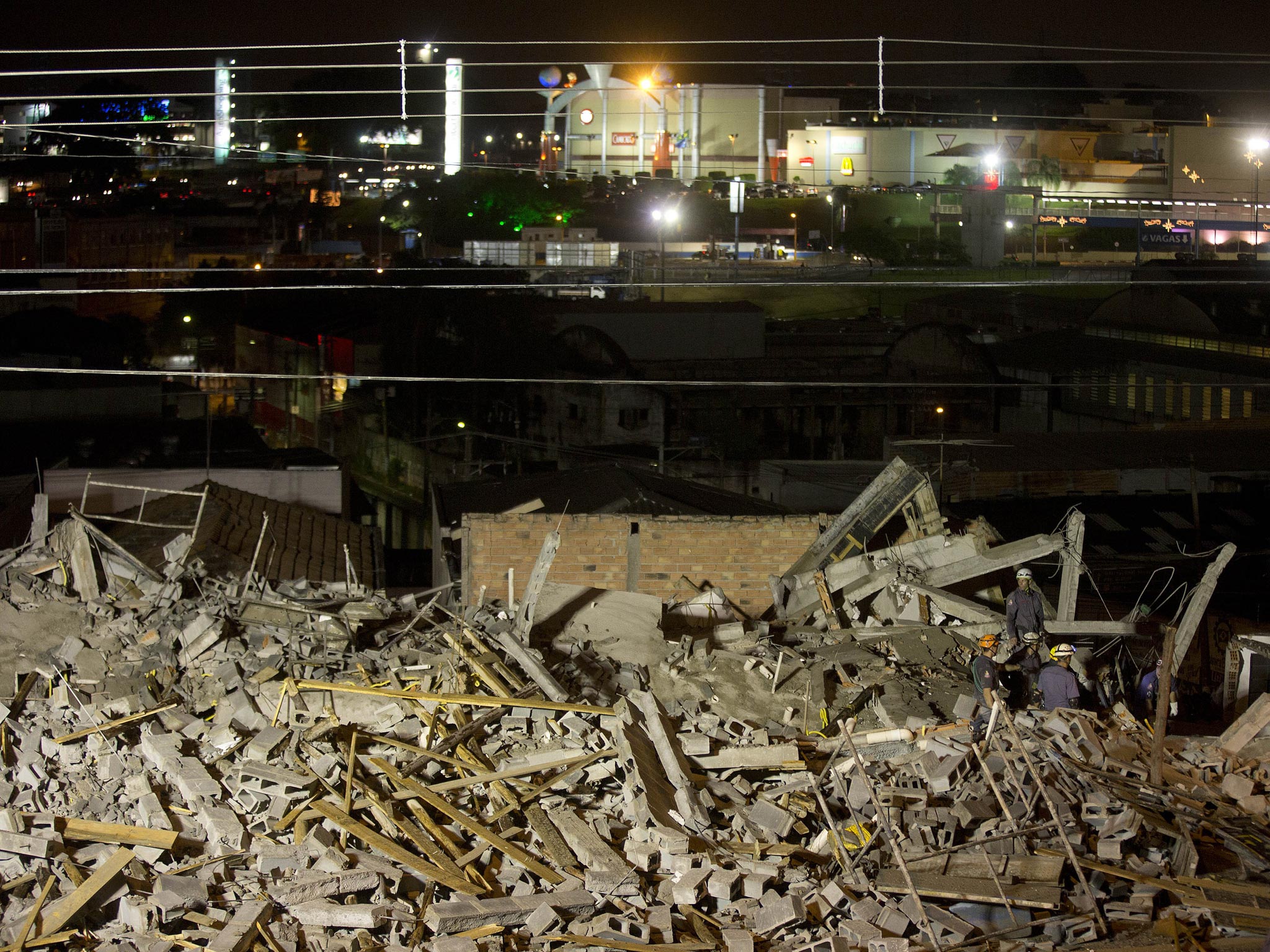 Firefighters search in the the rubble of a collapsed building in Guarulhos, outskirt of Sao Paulo, Brazill