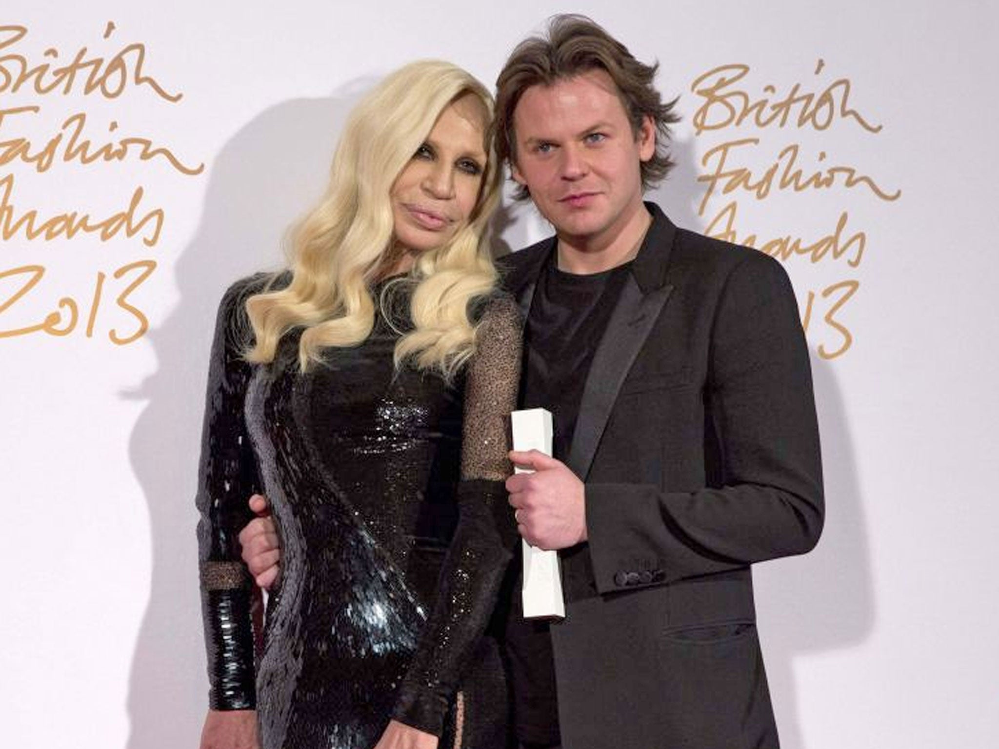 Italian designer Donatella Versace poses with British designer Christopher Kane, winner of the Womenswear Designer of the Year Award, at the British Fashion Awards in London yesterday